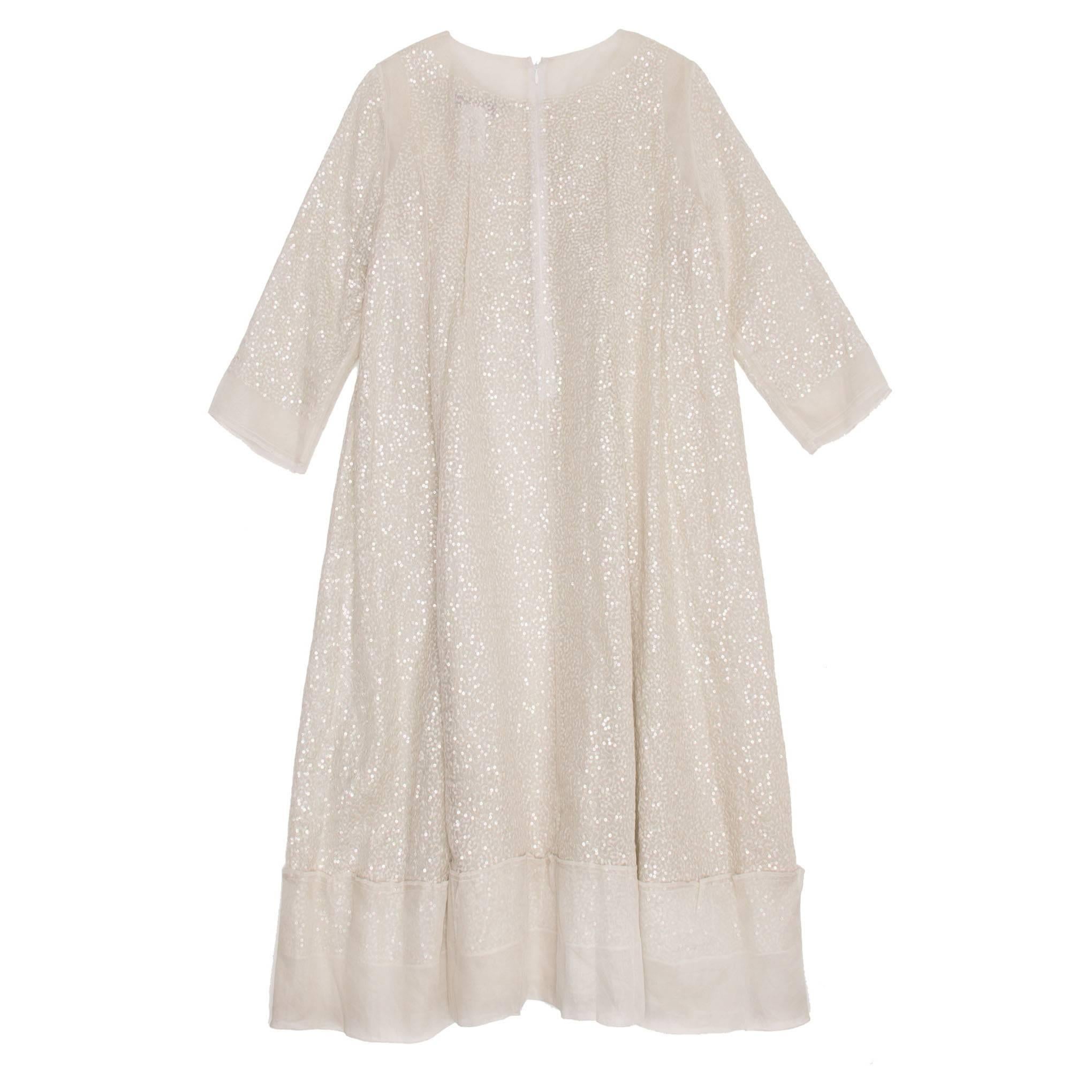 Ivory silk organza tunic fully embellished by hand stitched sequins. The sleeves are 3/4 style and the total dress length is to the knees. Made in France.

Size  42 French sizing
Condition  Excellent: never worn