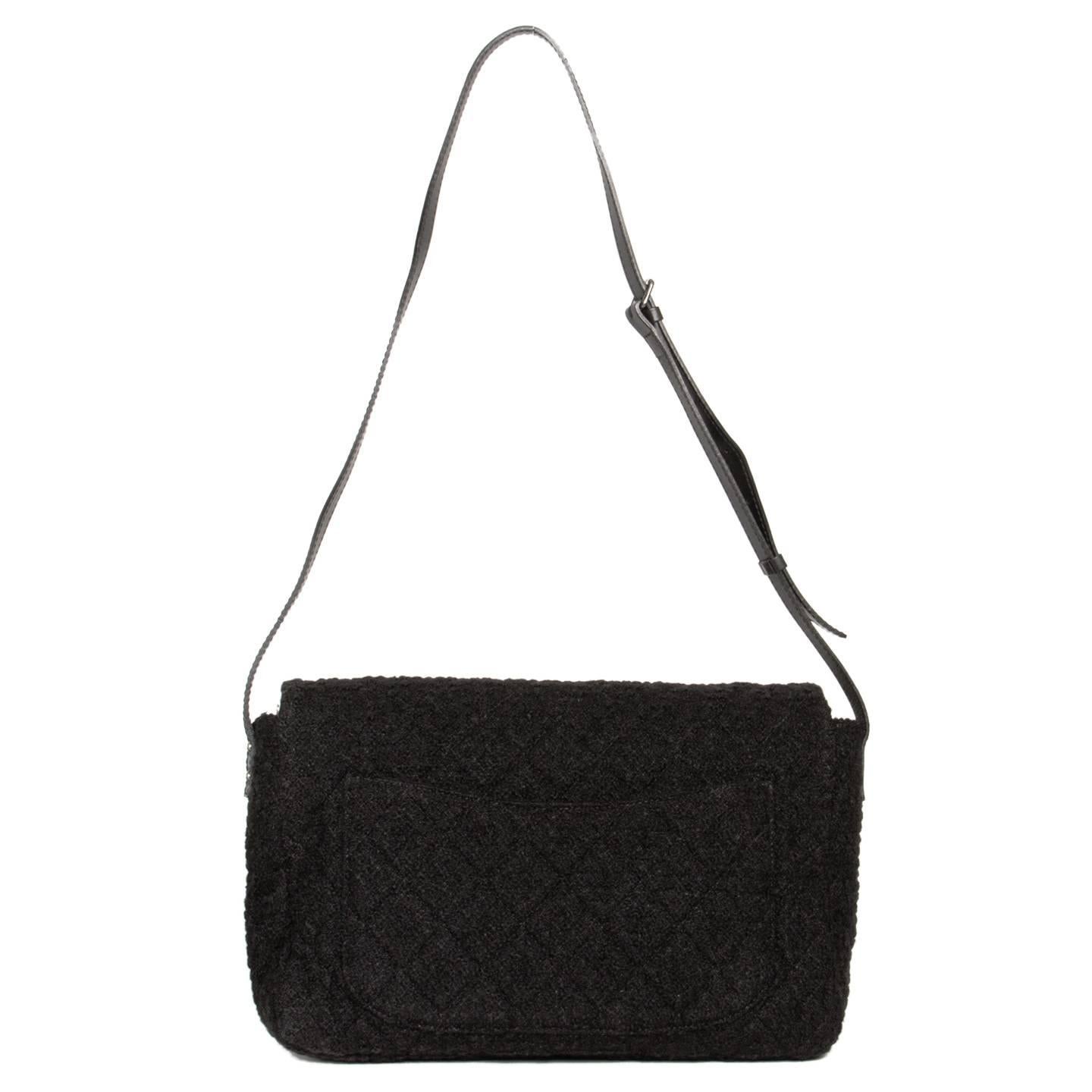 Large classic quilted Chanel style bag with a fun twist given by the black boucle wool. The bag has a black leather cross-body adjustable strap and fastens with a silver buckle. Made in France.

Size  H 11" L 18" W 5" STRAP 55.5"