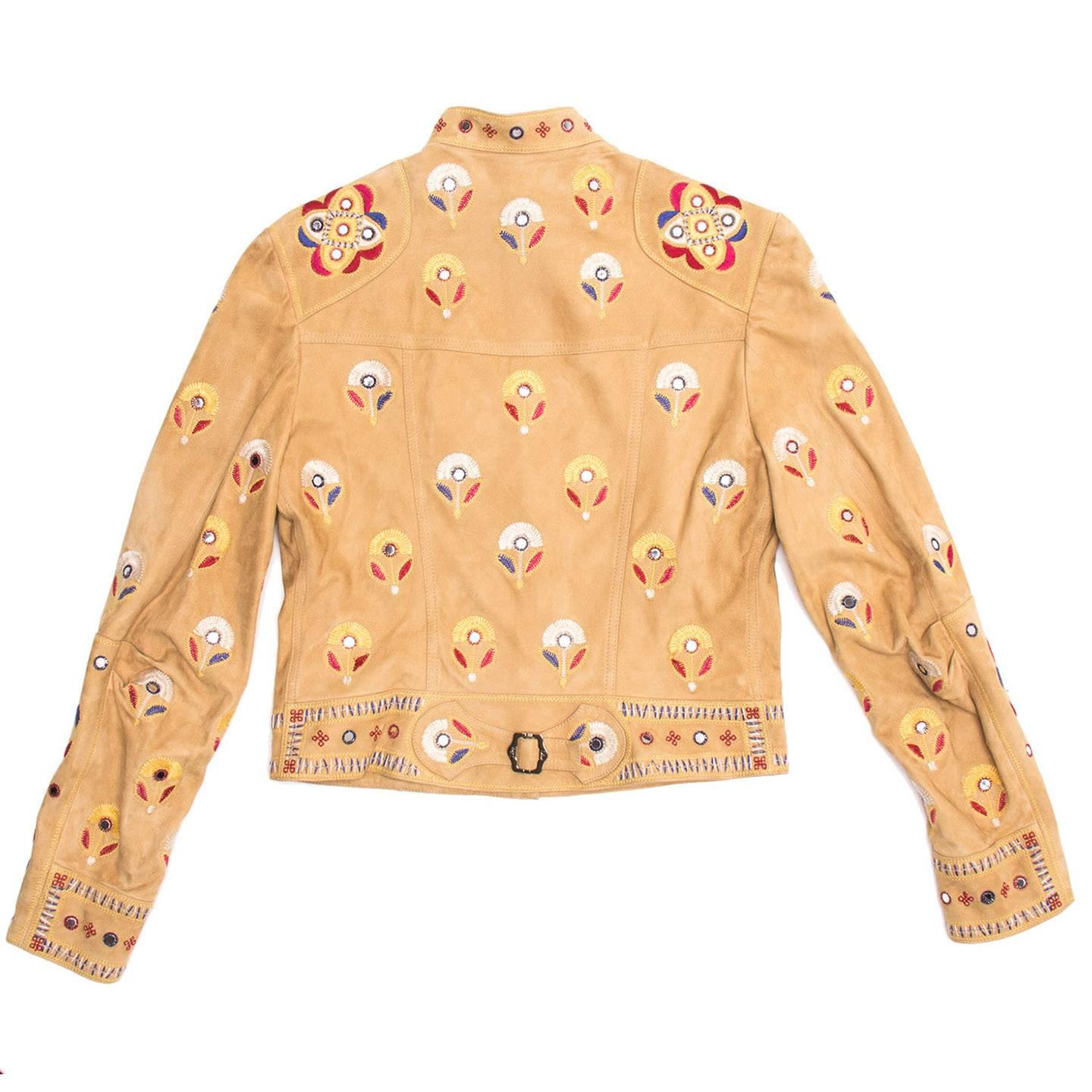 Indian textile inspired tan suede moto jacket. The jacket is enriched by a beautiful white, red, blue and yellow floral embroidery with mirror details. Made in France.

Size  40 French sizing
Condition  Excellent: never worn
