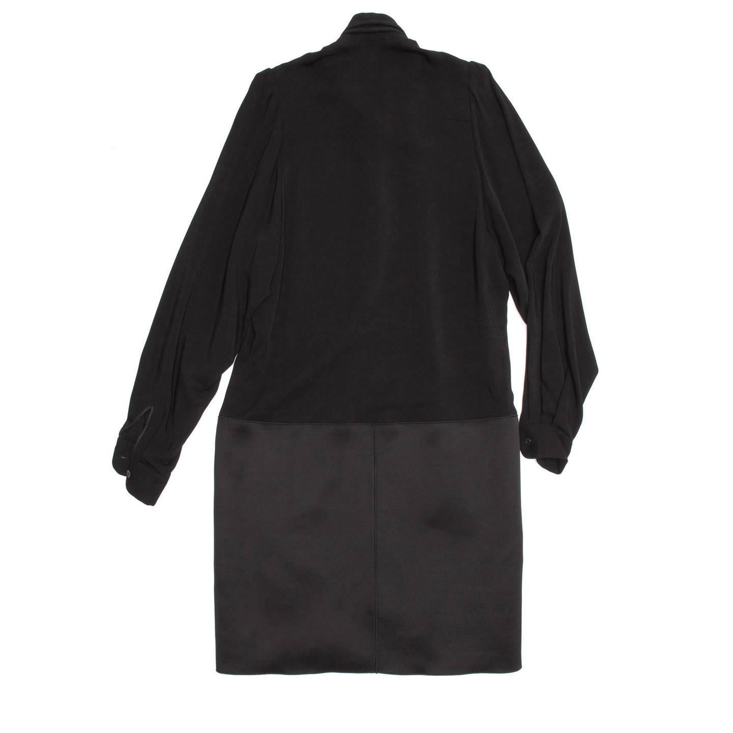 Viscose/wool black long sleeve drop waist dress with tie neck detail and pocketed silk skirt. Made in France. Purchased in Paris.

Size  38 French sizing

Condition  Excellent: never worn with tags