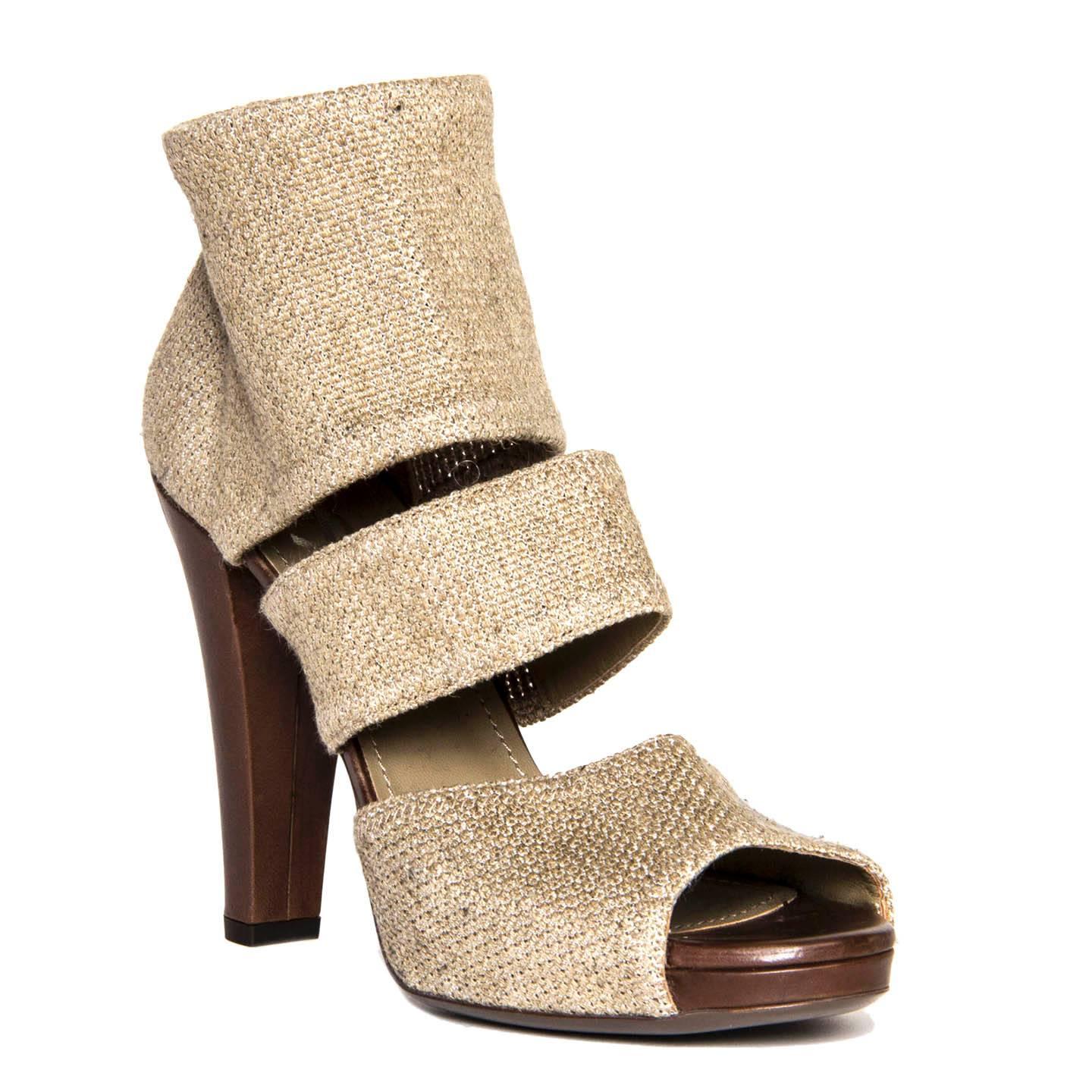 Sand color burlap peep toe sandals with a wide strap at ankle and a smaller one at mid-foot. The top strap is elastic to let the foot slip in the sandal easily. The front of the platform is covered in dark brown leather as well as the heel, which is