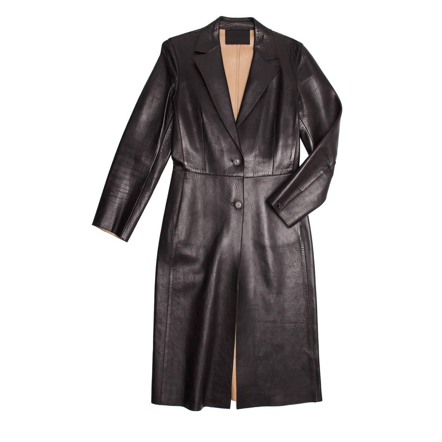 2 buttoned black supple leather bonded coat. Inseam pocket at hip. Single button closure at back cuff. Long back vent for movement and tan interior lining.

Size  44 Italian sizing

Condition  Excellent: worn a few times