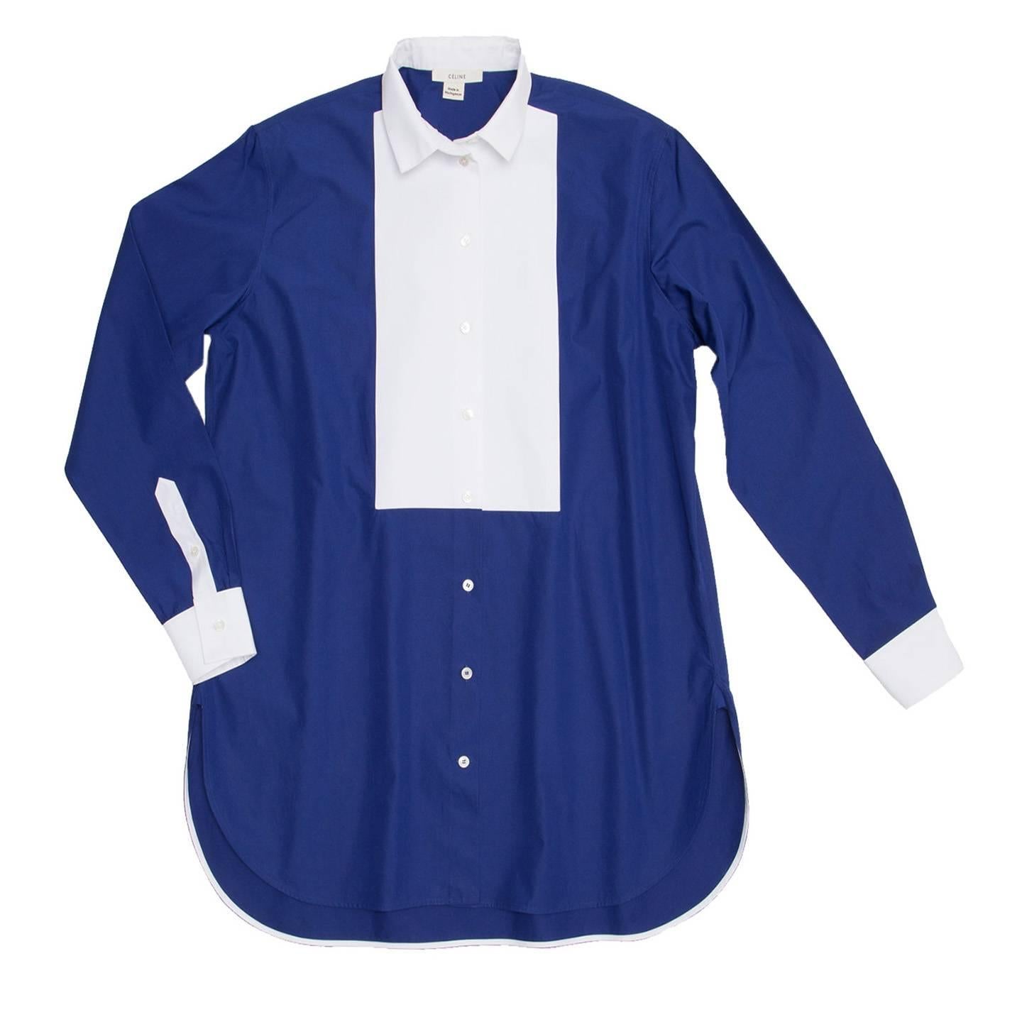 Cobalt blue shirt with white cuffs, buttons and inner hem binding matching the spread neck and bib detail. The fit of the shirt/tunic is long and comfortable and the hem is round with opening at side seams.

Size  38 French sizing

Condition 