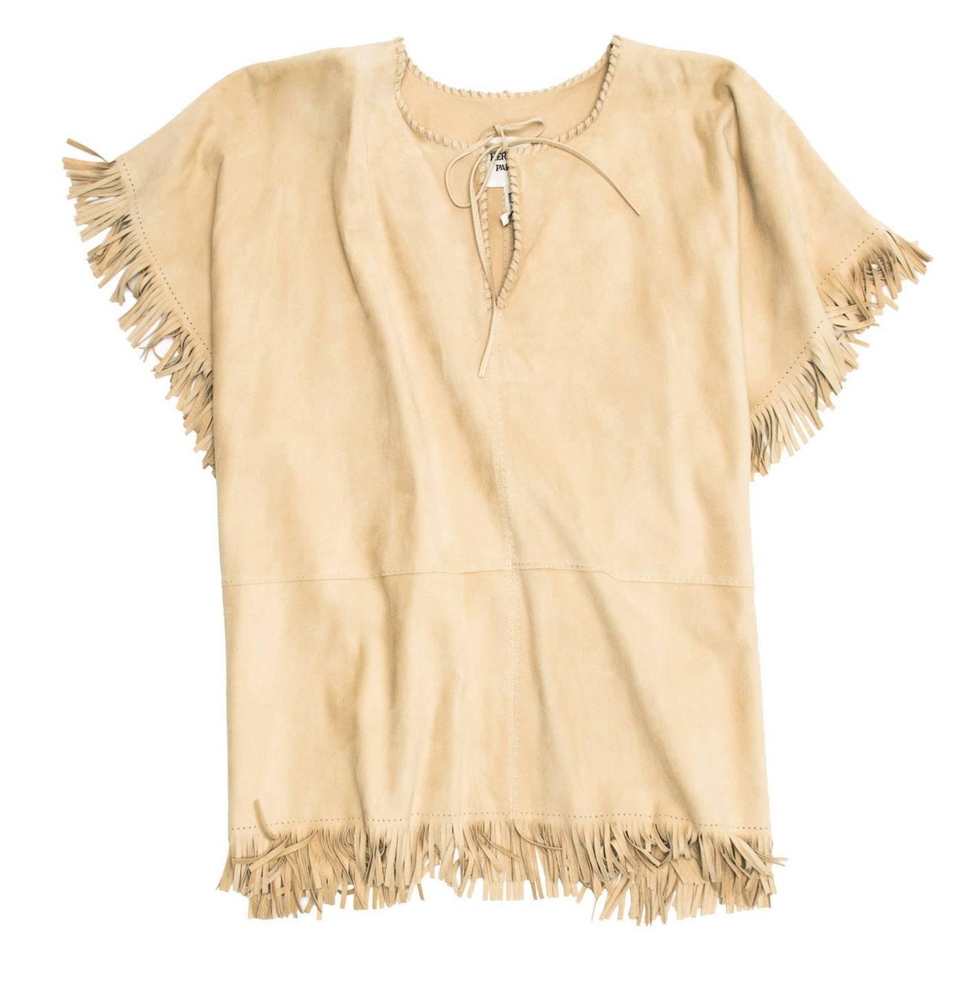 Natural color suede fringe poncho with whip-stitch V-neck tie collar and hidden ties at waist area.

Size: One size

Condition  Excellent: never worn