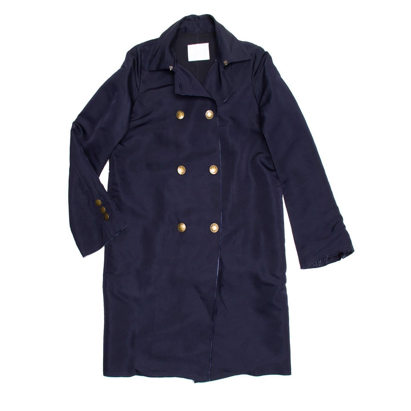 Lanvin 2008. Silk navy double breasted overcoat with brass buttons and raw finish trim on cuffs and hemline.

Size  42 French sizing

Condition  Excellent: worn a few times