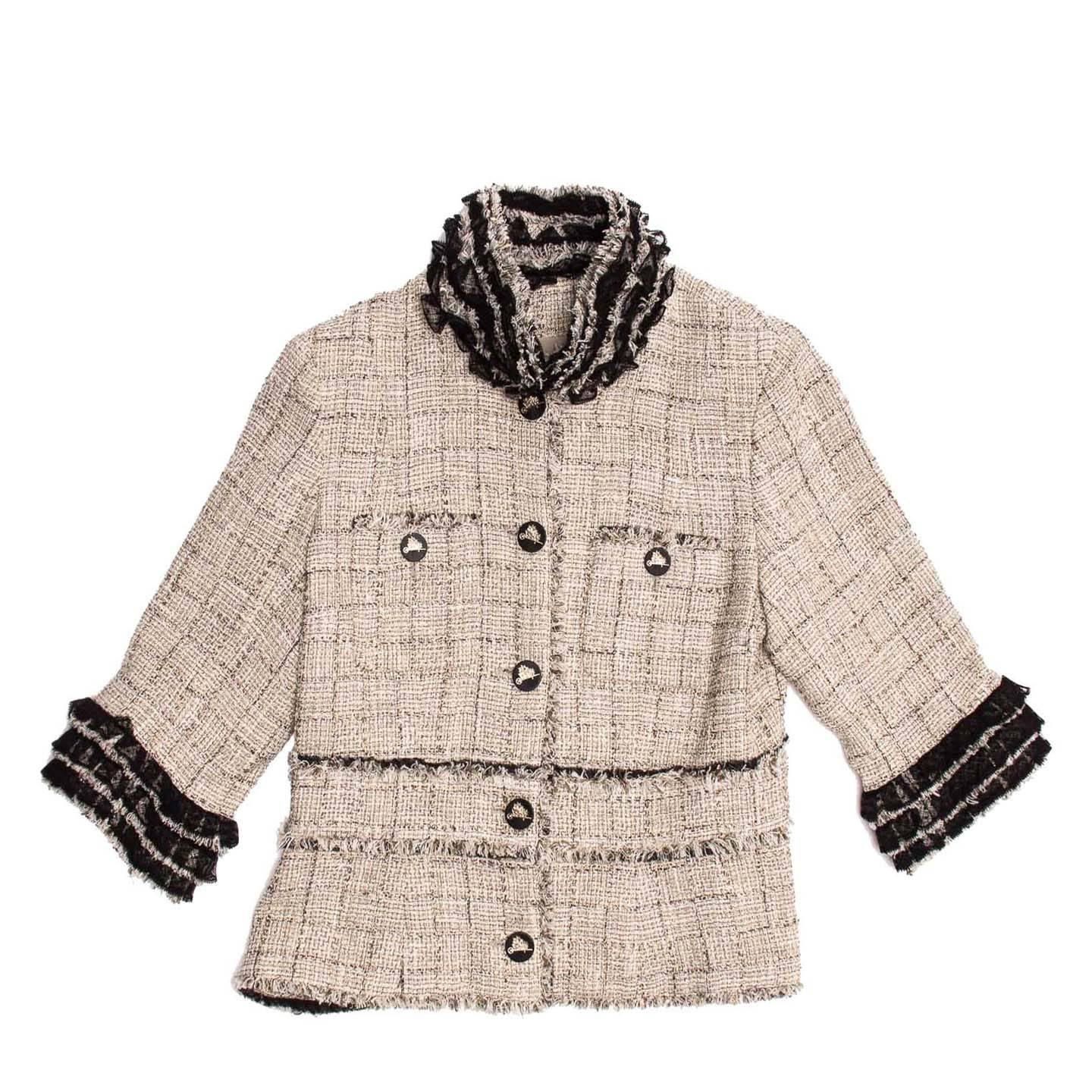 Beige cotton blend elegant 3/4 sleeves jacket with gold and silver threads. Black lace ruffles and fringing enriches the cuffs, collar and jacket body. The neck of the jacket can be transformed into a simpler round one by removing the top two