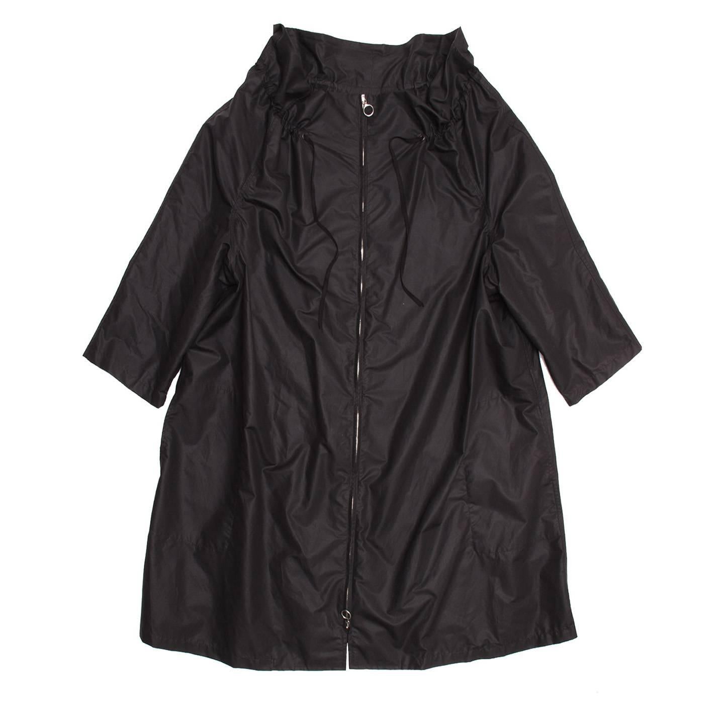 Lanvin 2008. Loose fit knee length black nylon raincoat with wide drawstring collar, 3/4 sleeves and silver metal open-ended zipper at front.

Size  42 French sizing

Condition  Excellent: never worn