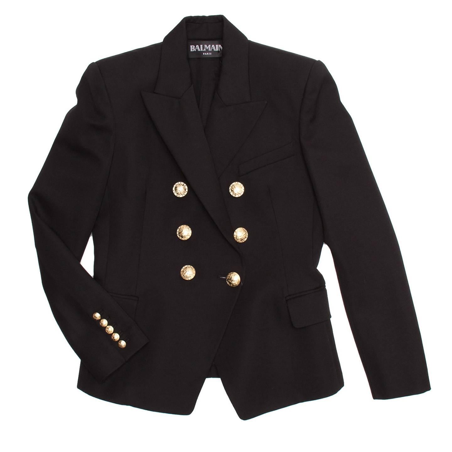 Double breasted black tailored wool coat with gold ornate buttons. Peaked lapels with handkerchief pocket at front. 5 rows of buttons at back cuff and flap pockets at the sides. New with tags.

Size  44 French sizing

Condition  Excellent: never