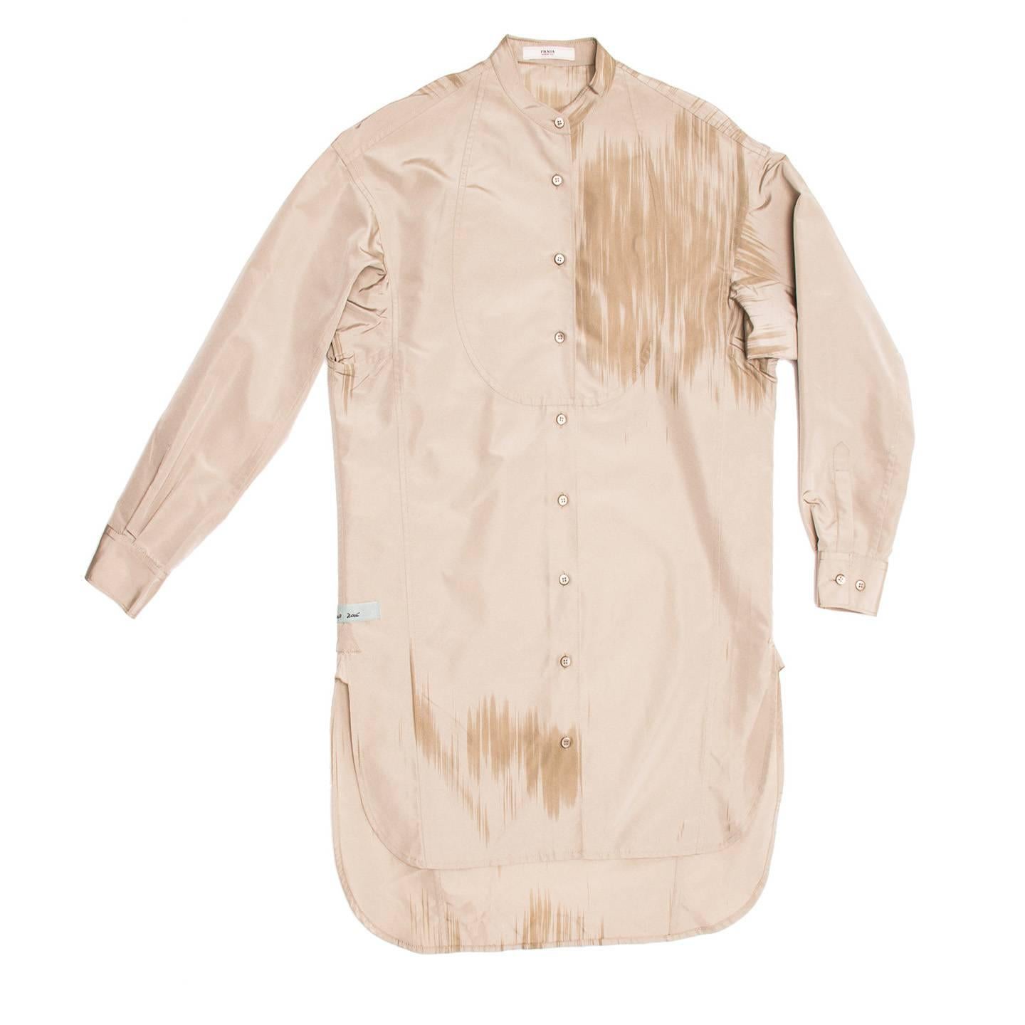 Taupe silk/polyester tunic style comfortable shirtdress with Nehru collar, bib front and paint brush detailing at front and back. The hem is round with detailed vents at side seams and the back is longer than the front. Made for Art Basel.

Size 