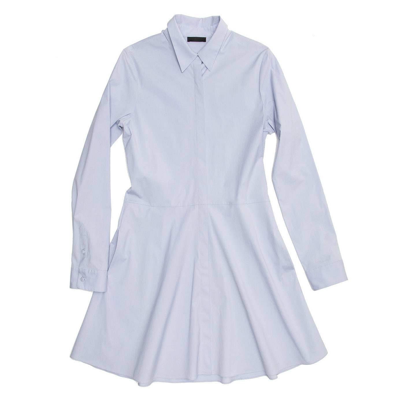 Light blue cotton and lycra shirt dress with drop waist seam and flared skirt with side pockets. The front buttons are covered by a flap and the ones on the cuffs and collar are self-fabric covered buttons.

Size  12 US sizing

Condition 