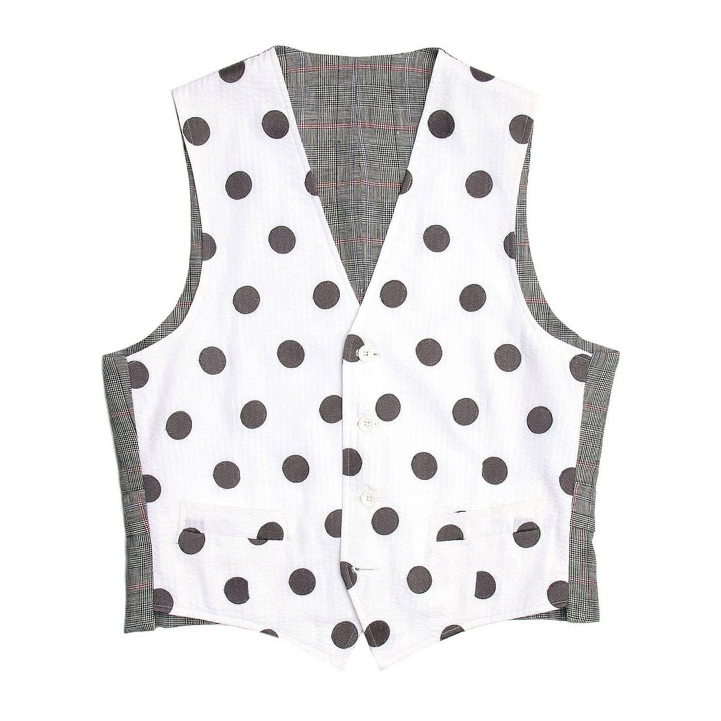 Seersucker vest with white cotton and wide grey polka dots front. The back of the vest is grey, white, blue and red tartan with a thin buckle back that fastens with two white rubber buttons to match the ones at front.

Size  1

Condition 
