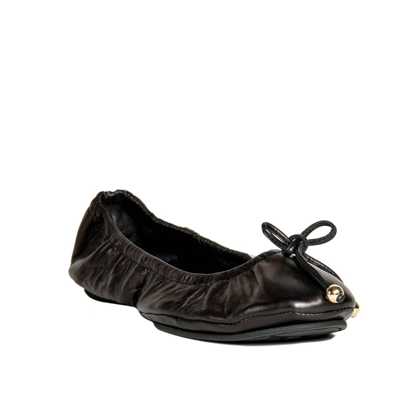 Black leather scrunch travel slippers/ballet flats with gold color ball detail on leather toe ties. Made in Italy.

Size  41 Italian Sizing

Condition  Excellent: never worn