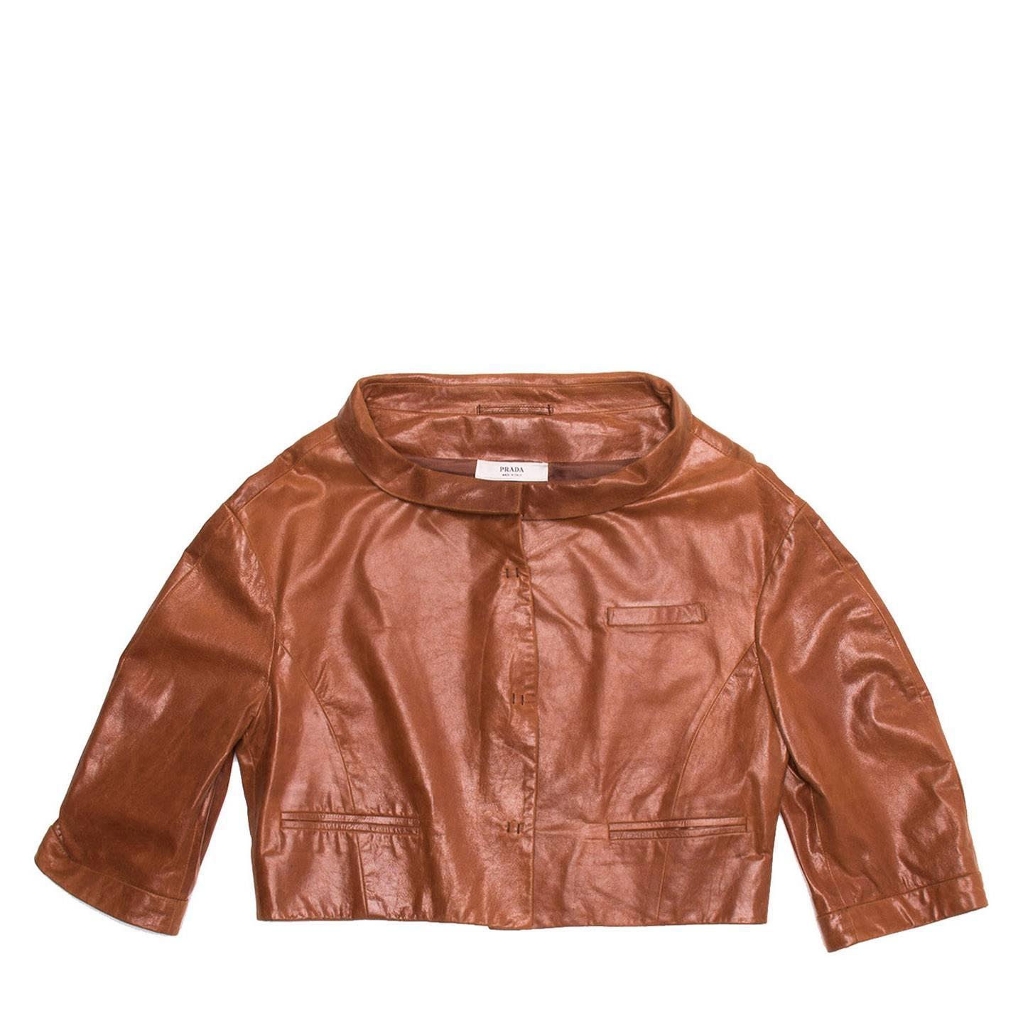 Brown leather cropped jacket with 3/4 length sleeves and snap front buttons.

Size  44 Italian sizing

Condition  Excellent: never worn
