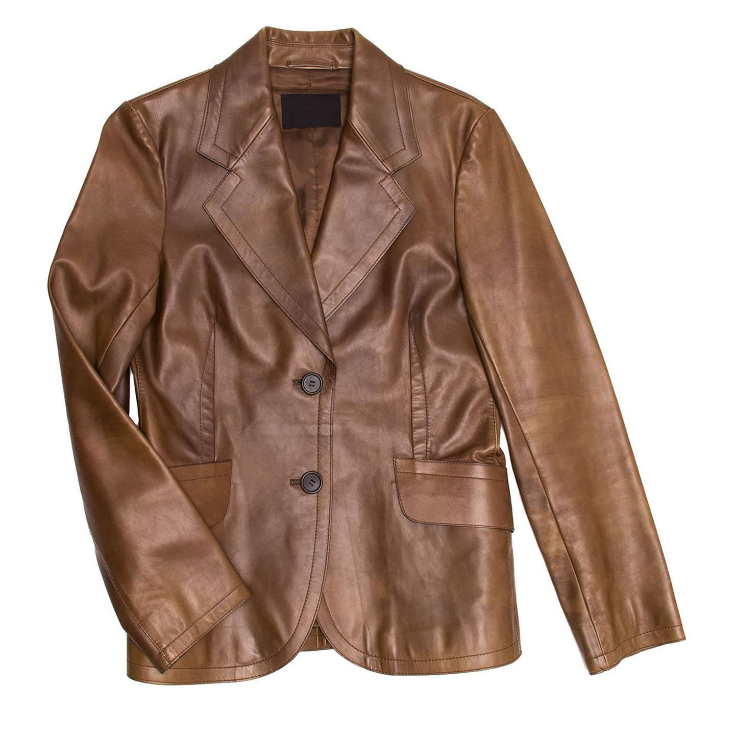 2 button toffee brown colored blazer in a subtle distressed leather. 2 pocket flaps at front side. Tonal topstitching detail along the pocket flaps and lapels.

Size  44 Italian sizing

Condition  Excellent: worn once