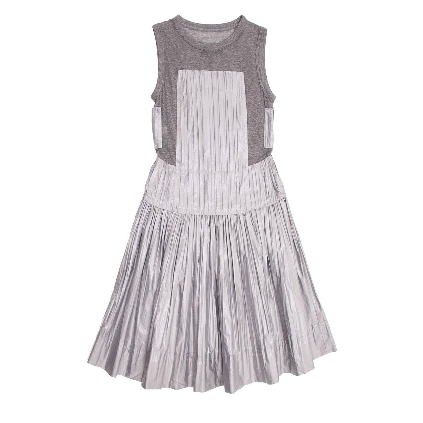 Light grey paper silk pleated dress with grey melange jersey tank-top insert. The top part fits well and the knee length skirt opens with an A-line volume.

Size  42 French sizing

Condition  Excellent: never worn