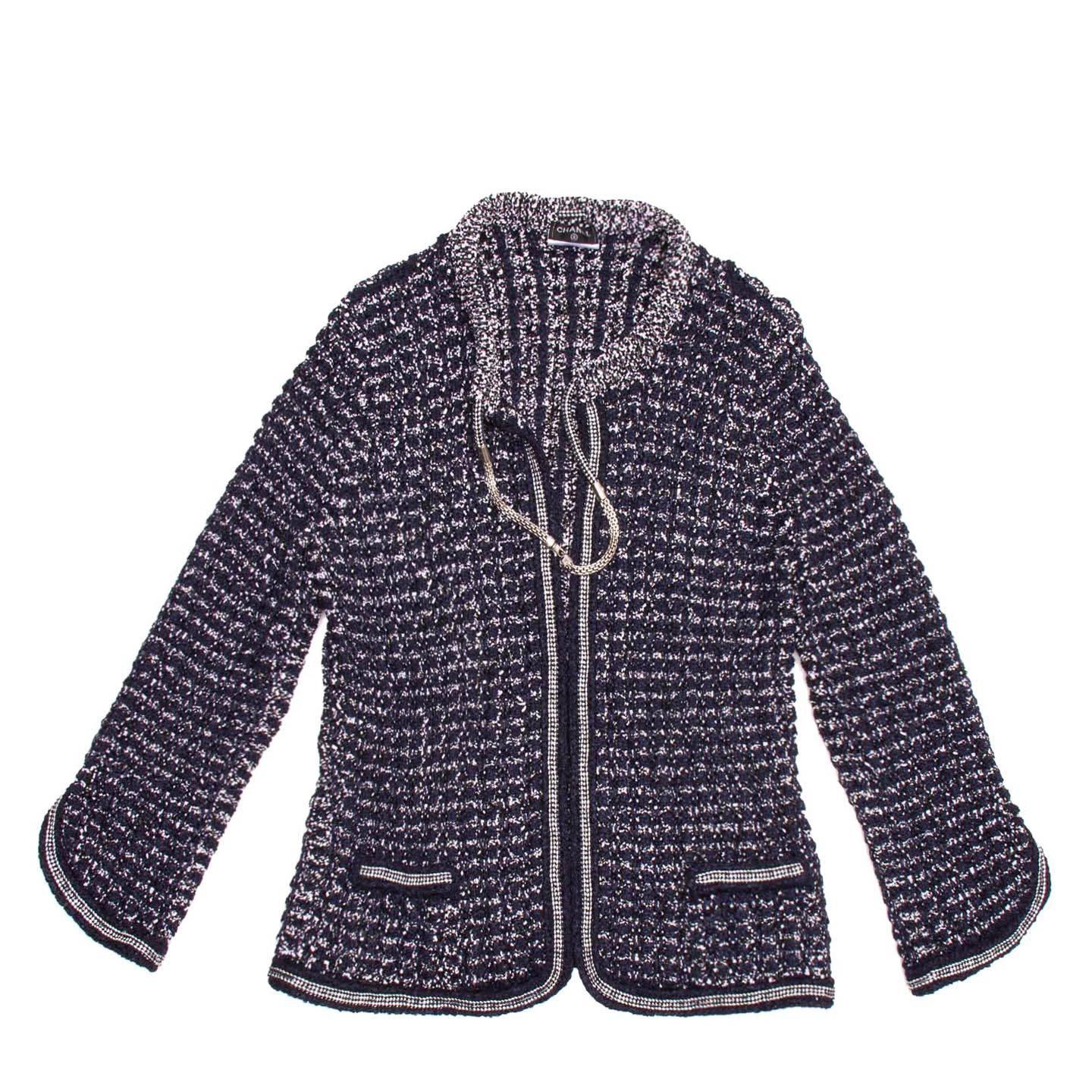 12P Collection: Signature tweed navy blue & white crochet knit cardigan style jacket with silver chain trim detail and drawstring neck closure giving the look of a necklace is attached to the jacket.

Size  42 French sizing

Condition  New and