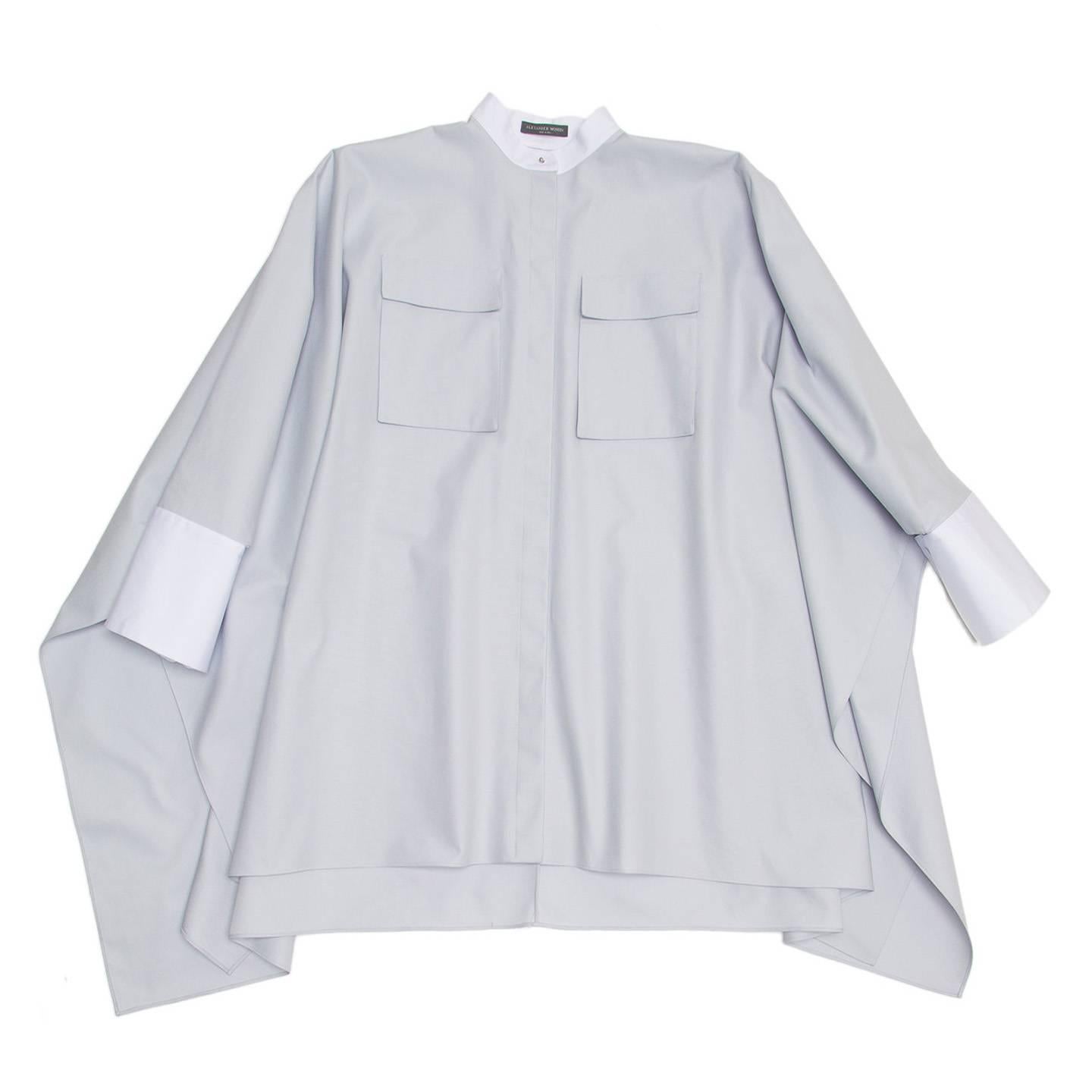 Sky blue pique cotton batwing/poncho style shirt with white collar and cuff. The mandarin collar is fastened with a metallic silver stud button and the french cuffs fasten with covered button cufflinks to match the plain and white cotton. The