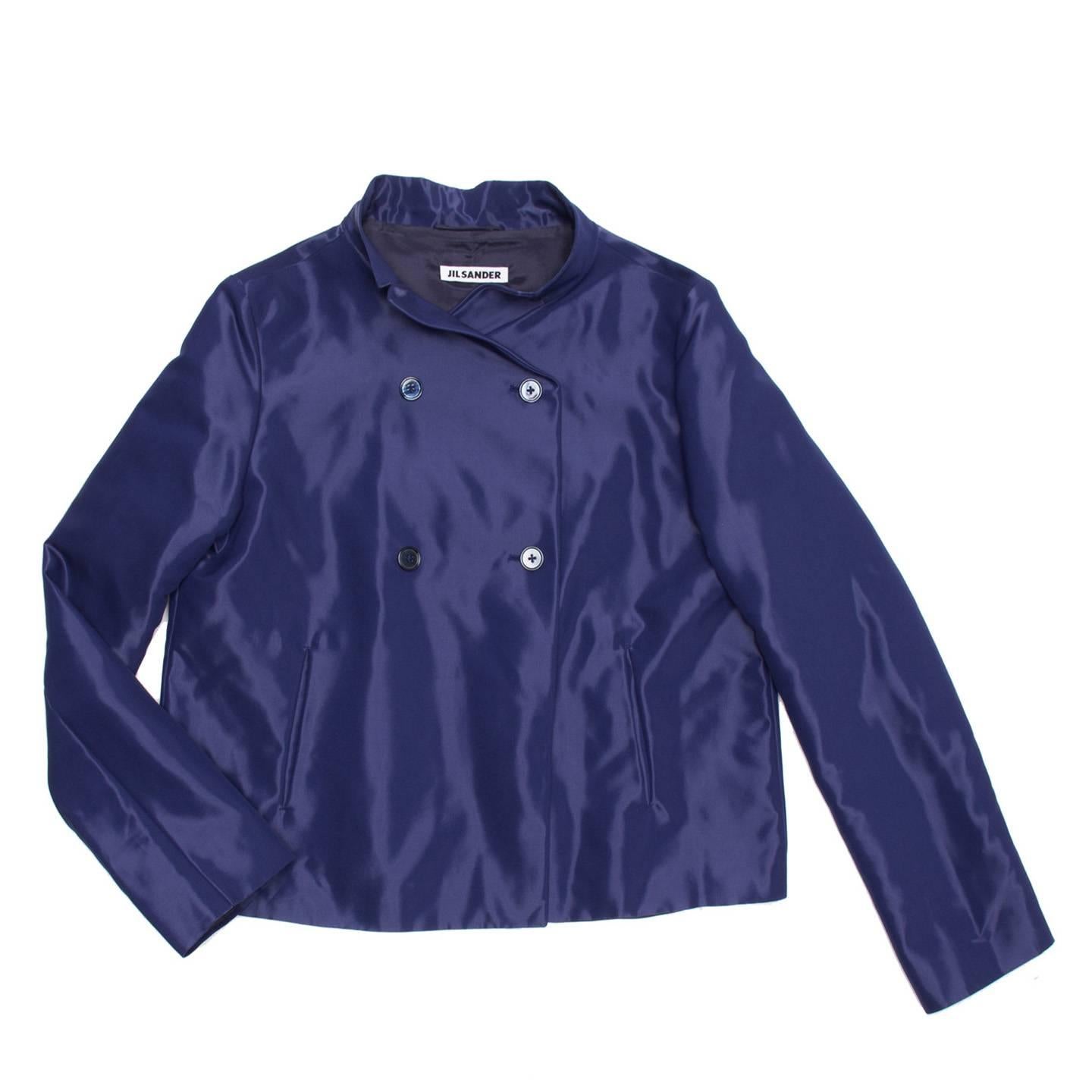 Midnight blue shiny cotton blend cropped jacket with a trapeze fit. The double breast is fastened with little dark blue buttons and the neck has a very small notch collar.

Size  40 French sizing

Condition  Excellent: never worn