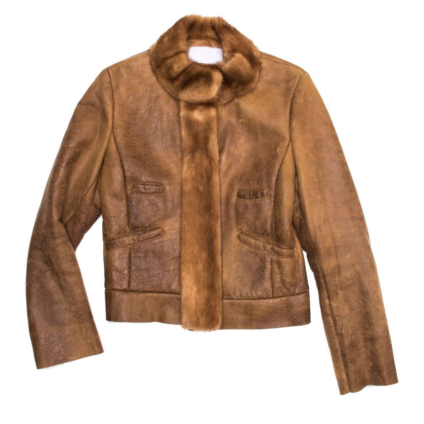 Fitted brown distressed leather shearling lined jacket with mink detailing on band collar and front jacket opening.

Size  44 Italian sizing

Condition  Excellent: worn a few times