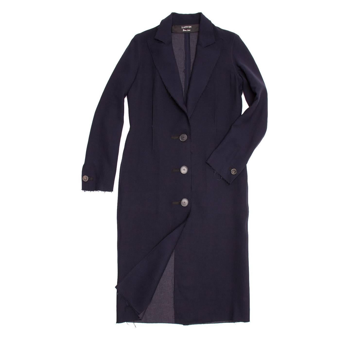 Lanvin 2004. Knee length navy blue wool tailored coat. 3 button closure at front and single button at back cuffs. Frayed edge detail along lapels, cuffs, and hem.

Size  40 French sizing

Condition  Excellent: worn a few times