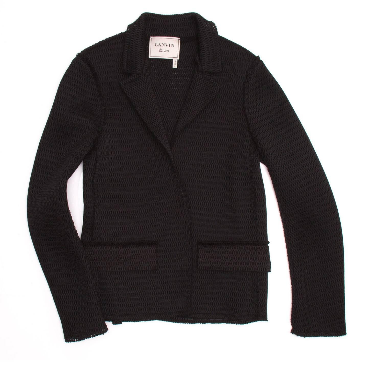 Lanvin 2013. Black single breasted perforated fabric blazer with large snap closures.

Size  42 French sizing

Condition  Excellent: never worn