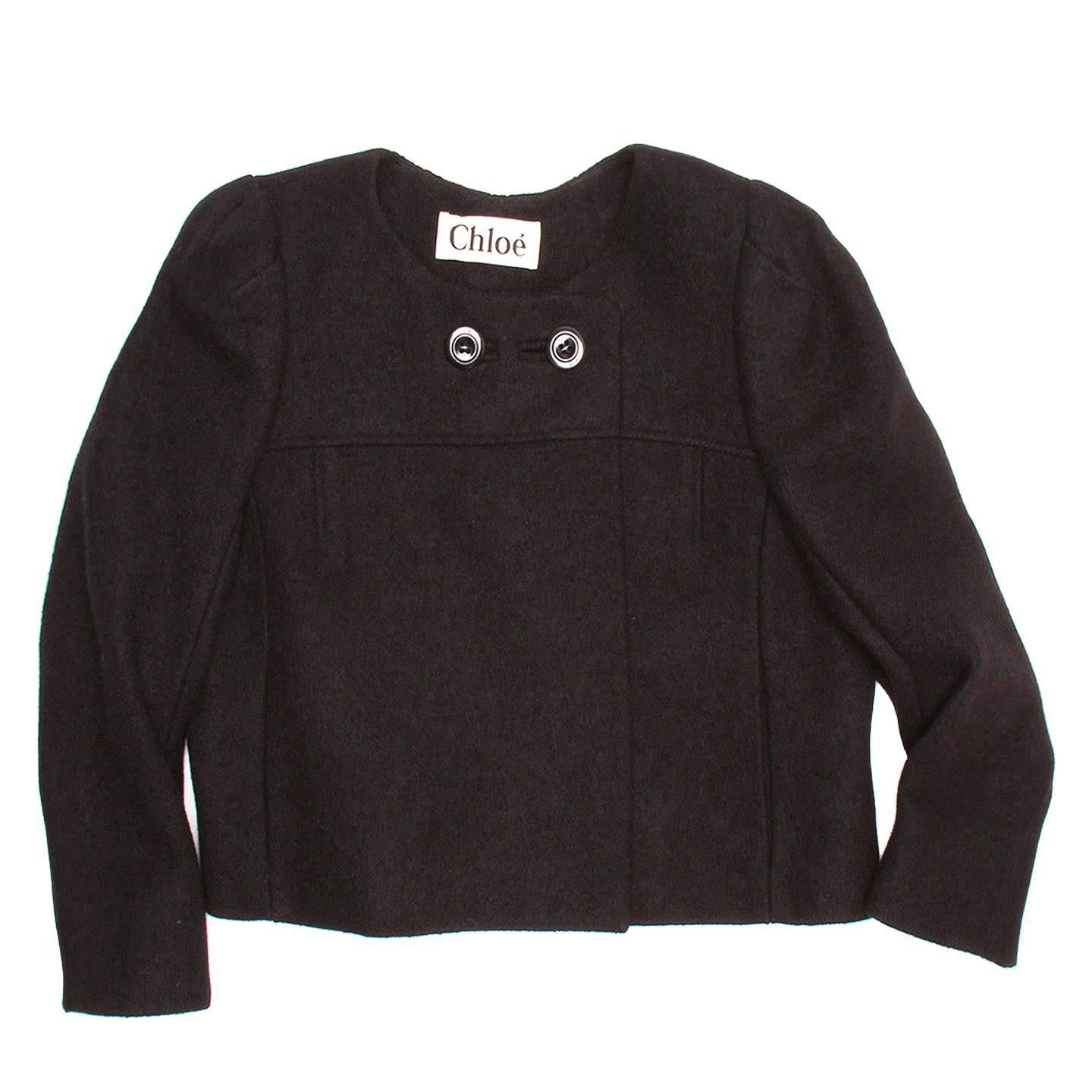 Cropped black boiled wool blazer with horizontal yoke and double black button detail on collar.

Size  44 French sizing

Condition  Excellent: never worn