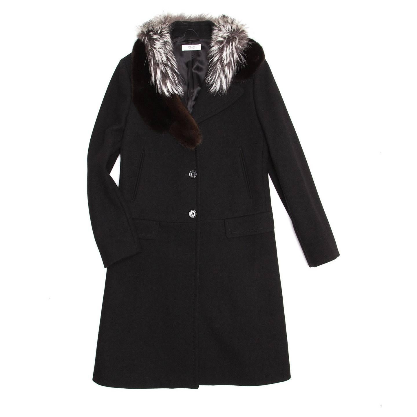 Black virgin wool single breasted knee length coat with 3 black buttons fastening the center front. The fit is straight with a drop waist line, two flap pockets sit on the seam and vertical slit pockets at waist. The main feature is the rich brown
