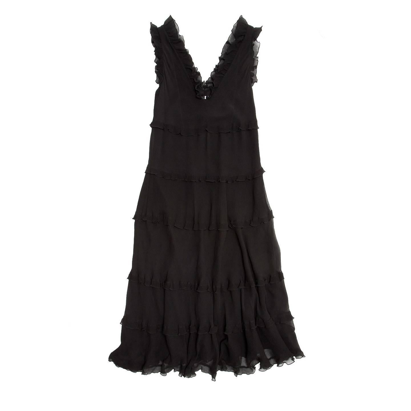 Black crinkle silk chiffon sleeveless dress with tiers and ruffles on each level, hem, around armholes and neck. The dress is ankle length, fully lined, with an A-shape line and a V-neck equally deep at front and back.

Size  44 Italian