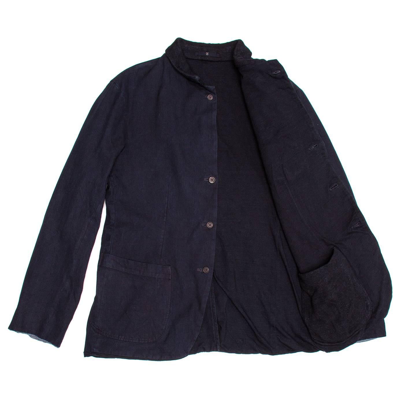 Reversible navy blue spring cotton jacket, hip length with back vent. One side of the jacket is made of woven, it has a breast pocket, two patch pockets and the convertible neck folds showing a knitted collar. If worn on the opposite side the jacket