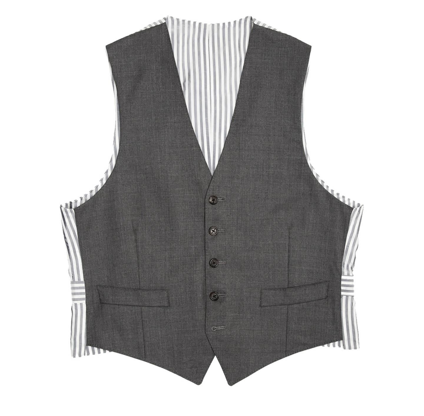 Fall 2008 heather grey wool vest with grey & white striped back panel and adjustable buttoned back detail. Made for Man Worn by Women. Hand made in New York.

Size  1 

Condition  Excellent: worn a few times