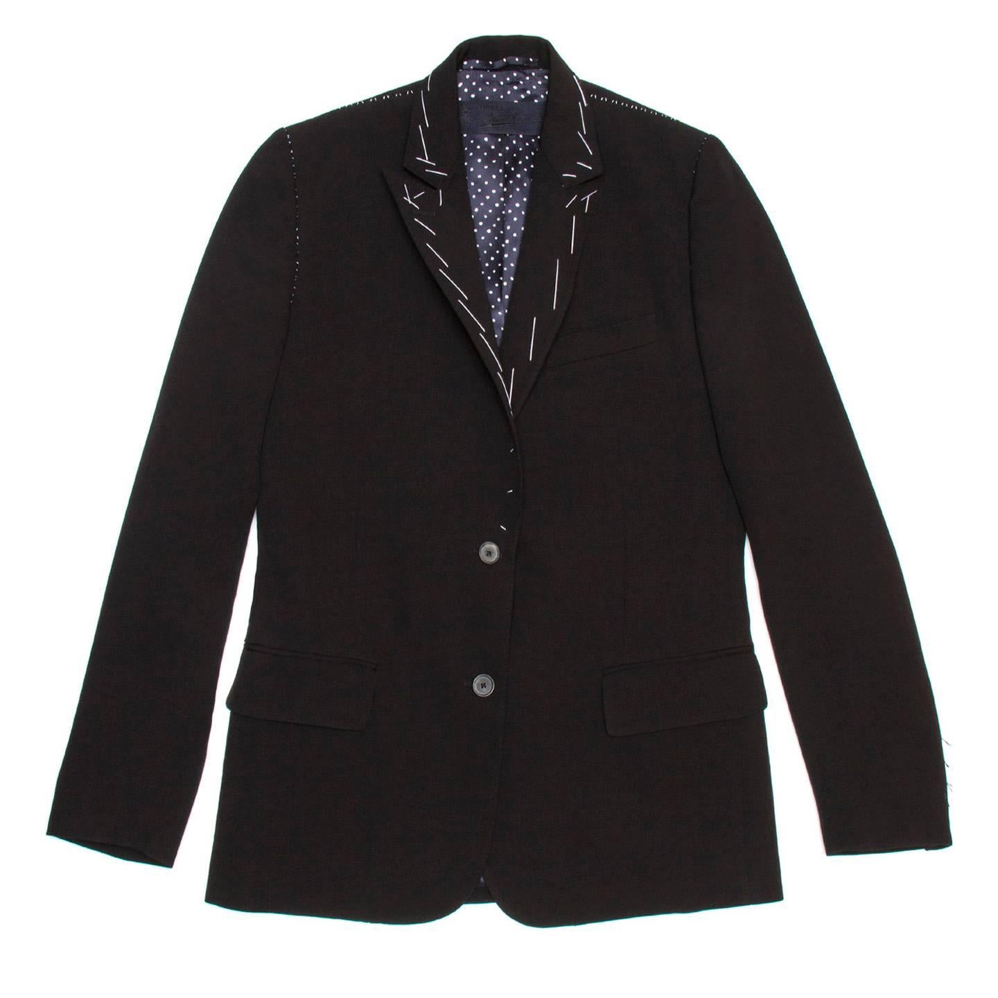 Black virgin wool blazer with small peaked lapel, 2 button closure, flap pockets and 2 back vents. The focal point and unique aspect of the jacket is the tailor white hand stitches on collar, lapel, vents and on shoulders and armholes seams. An