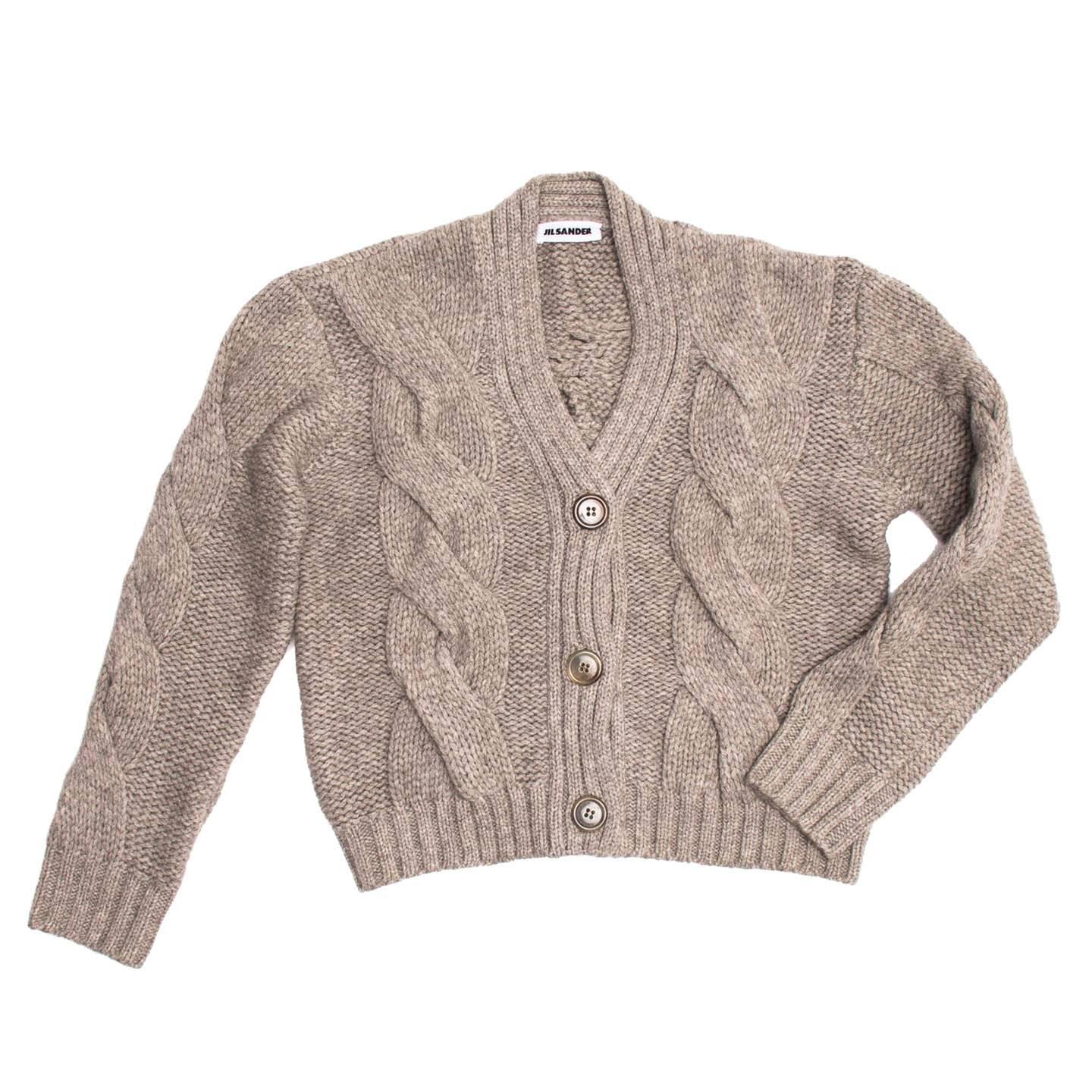 Heather grey/taupe cable knit cropped cardigan with 3/4 sleeves.

Size  38 French sizing

Condition  Excellent: worn a few times