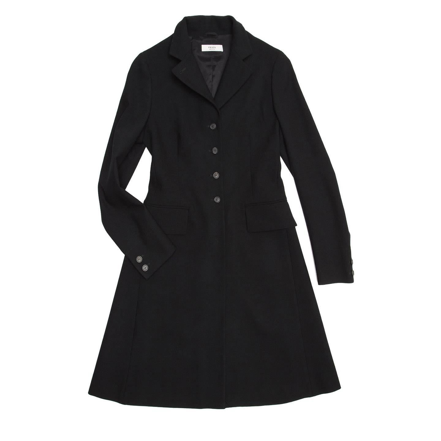 Black wool english riding vintage style coat, single breasted with small notched collar and front flap pockets. The fit is tight at top part and sleeves, while it is wider at skirt part.

Size  44 Italian sizing

Condition  Excellent: worn once
