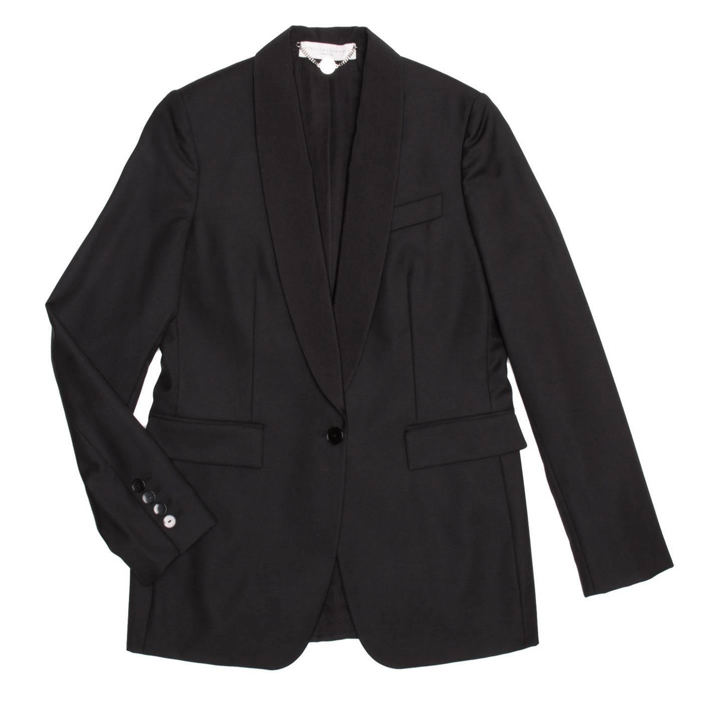 Black wool tuxedo style tailored jacket. Long shawl collar in a contrasting tonal fabric and a single button opening. 2 pocket flaps at front and back cuff vent with 4 buttons.

Size  44 Italian sizing

Condition  Excellent: never worn