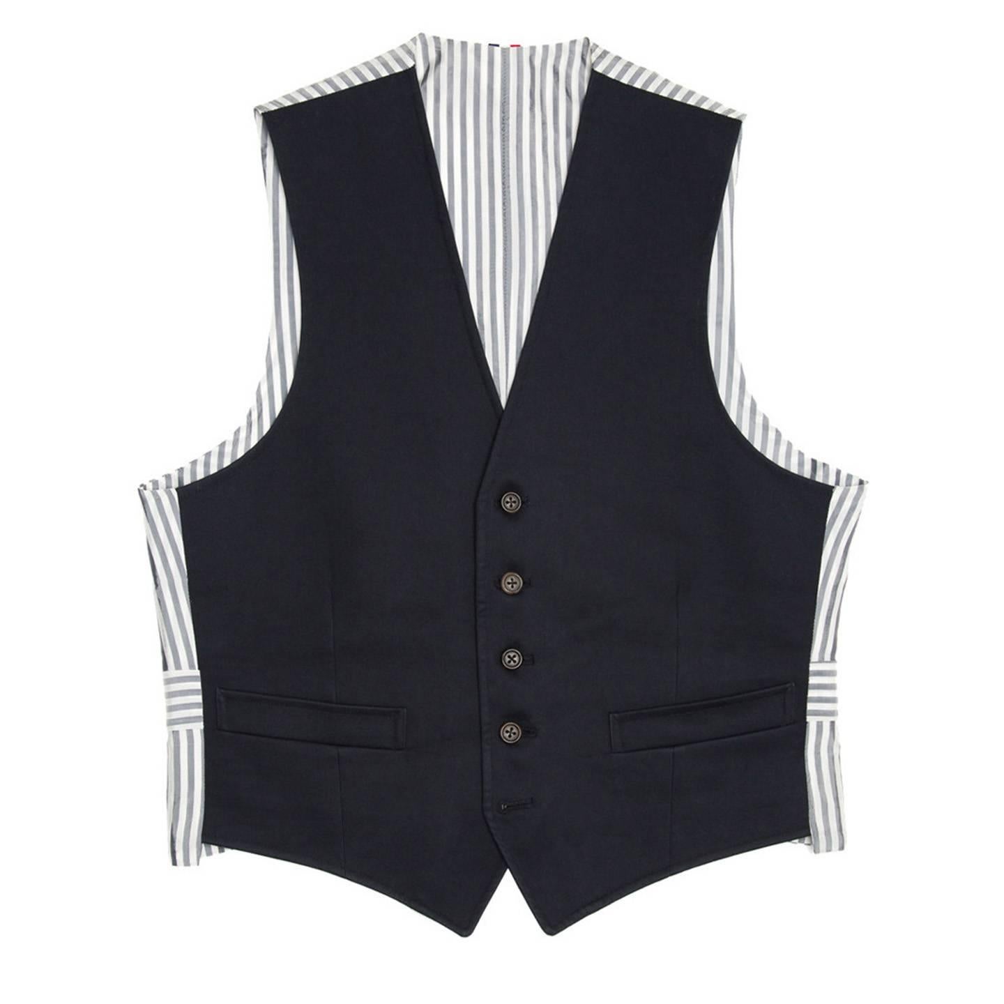Fall 2010 navy blue Mackintosh fabric vest with blue & white striped back panel and adjustable buttoned back detail. Made for Man Worn by Women. 

Size  1

Condition  Excellent: worn a few times
