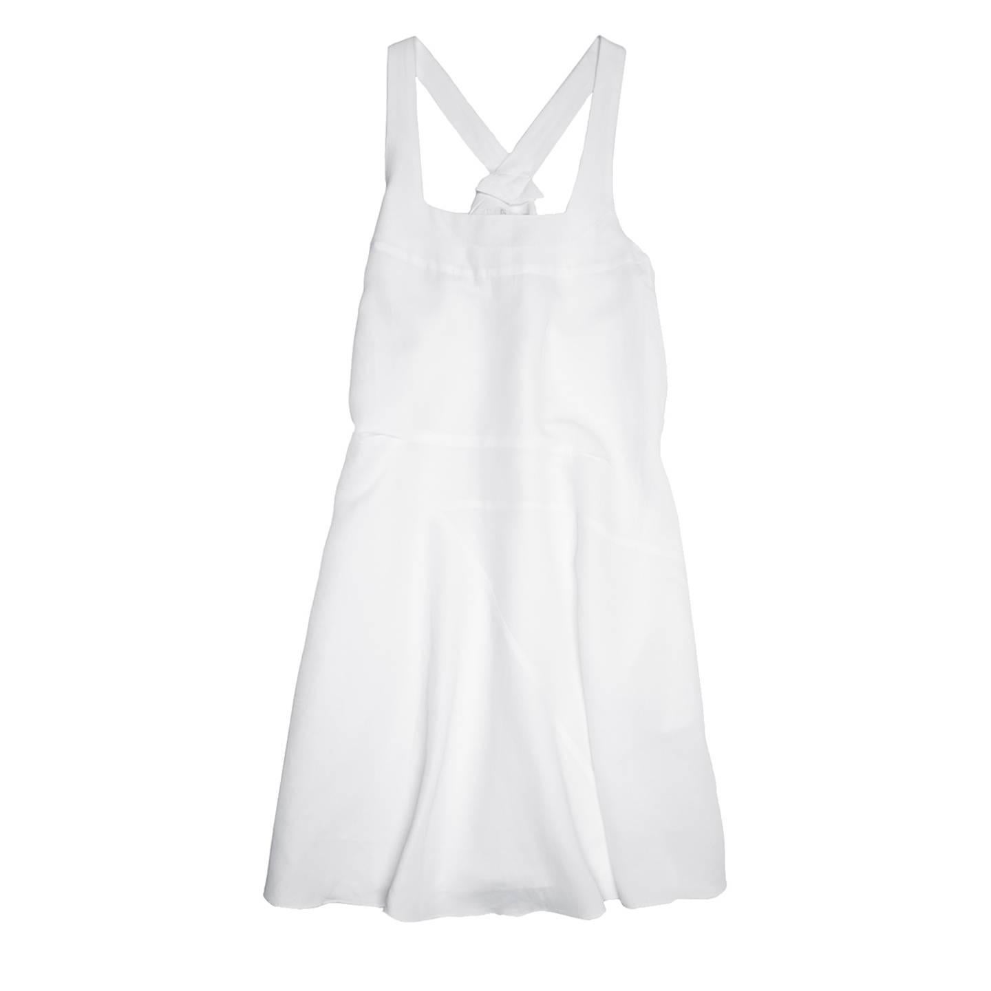 White viscose & ramie blend knee length dress made of bias panels that create a fluid A-shape volume. The back is enriched by a pleat fixed at waist and let free to neck and at hem, while a horizontal pleat detail embellish the front under bust