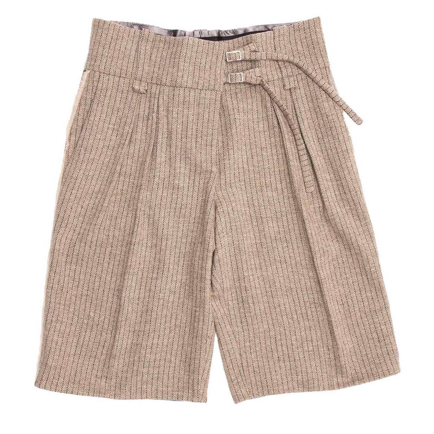 Khaki Bermuda Style Herringbone Wool Shorts. Button front closure with 2 thin belt at wide waist band. 2 pleats and front and single welt pockets at back. Sequin tuxedo pant style taping down sides.

Size  42 French sizing

Condition  Excellent:
