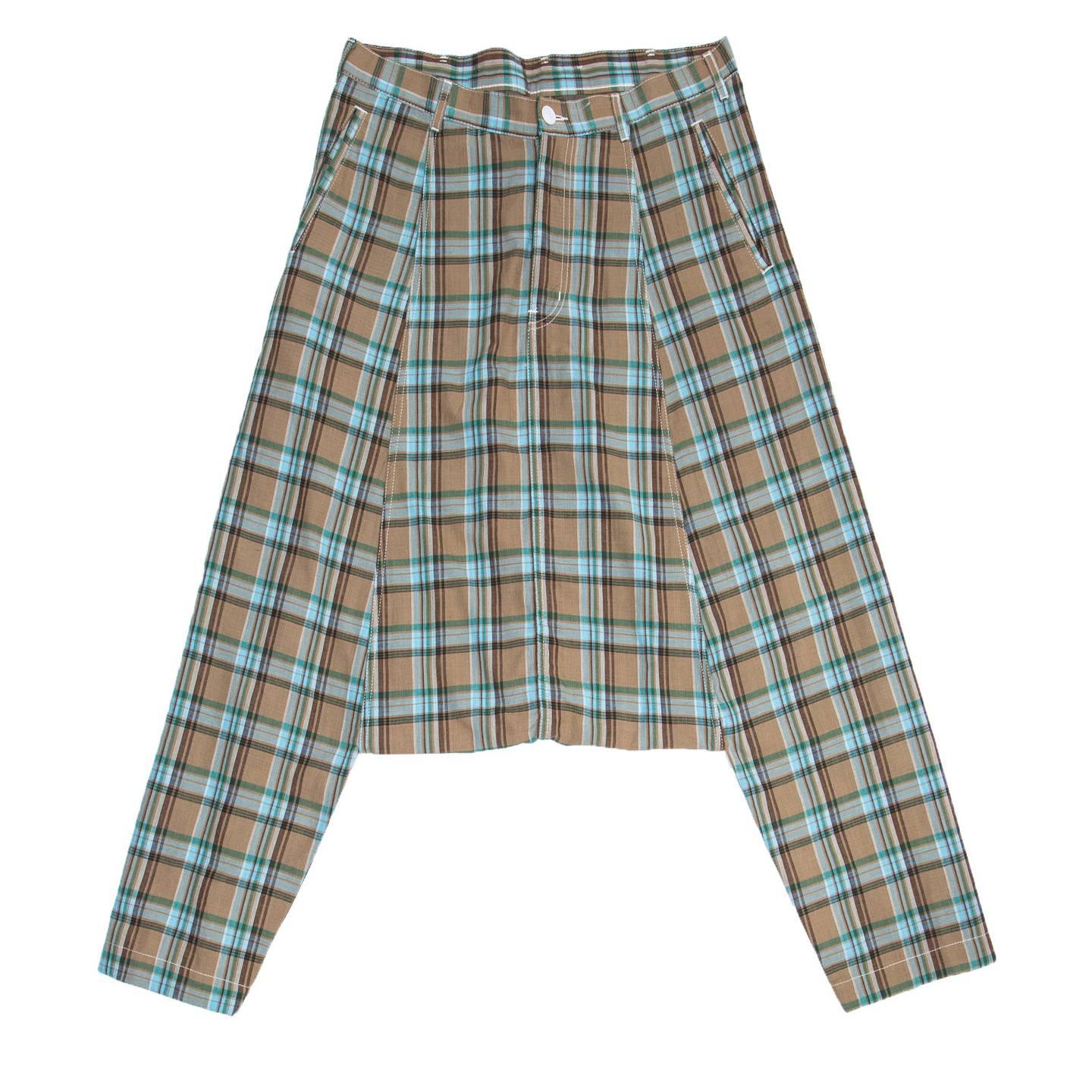 Brown, green and baby blue cotton plaid harem style long pants with very low crotch to below knees. The front pockets are classic slit style while at the back the patch pockets are round and wide. All the seams are enriched by white top stitches to