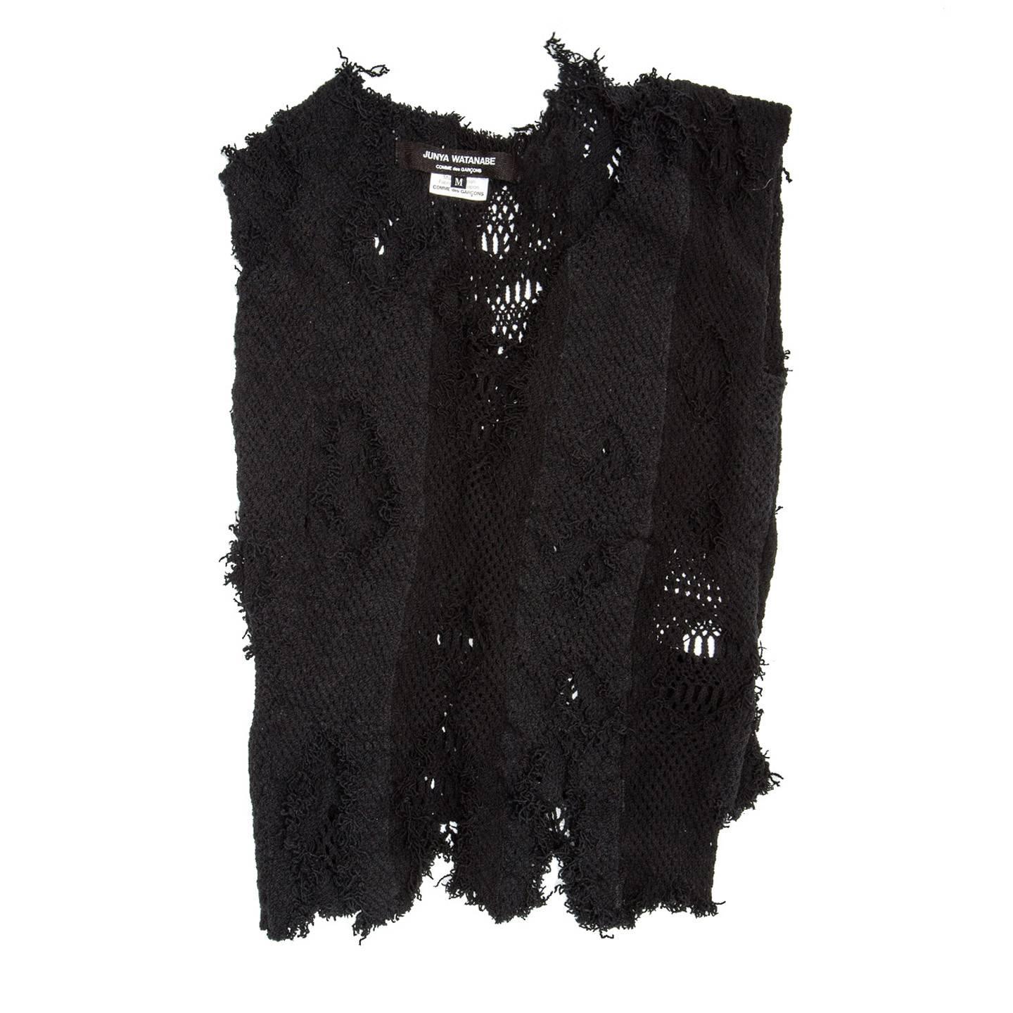 Loosely woven stretchy black cotton V-neck vest. Two layers of knit are assembled together creating a very interesting shredded looking texture.

Size  M Universal sizing

Condition  Excellent: never worn

 