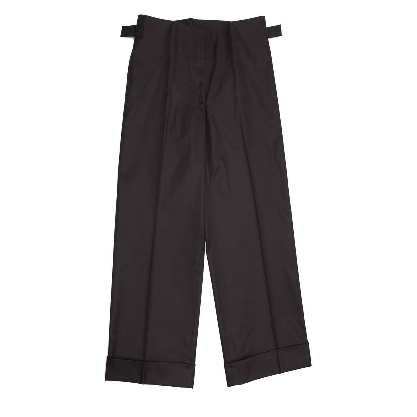 Black cotton suit pleated gaucho slack trousers with front slash pocket on the side seams and wide classic turn-ups. Two silver buckles at side seams enrich the waist and make it adjustable.

Size  42 French sizing

Condition  Excellent: never worn