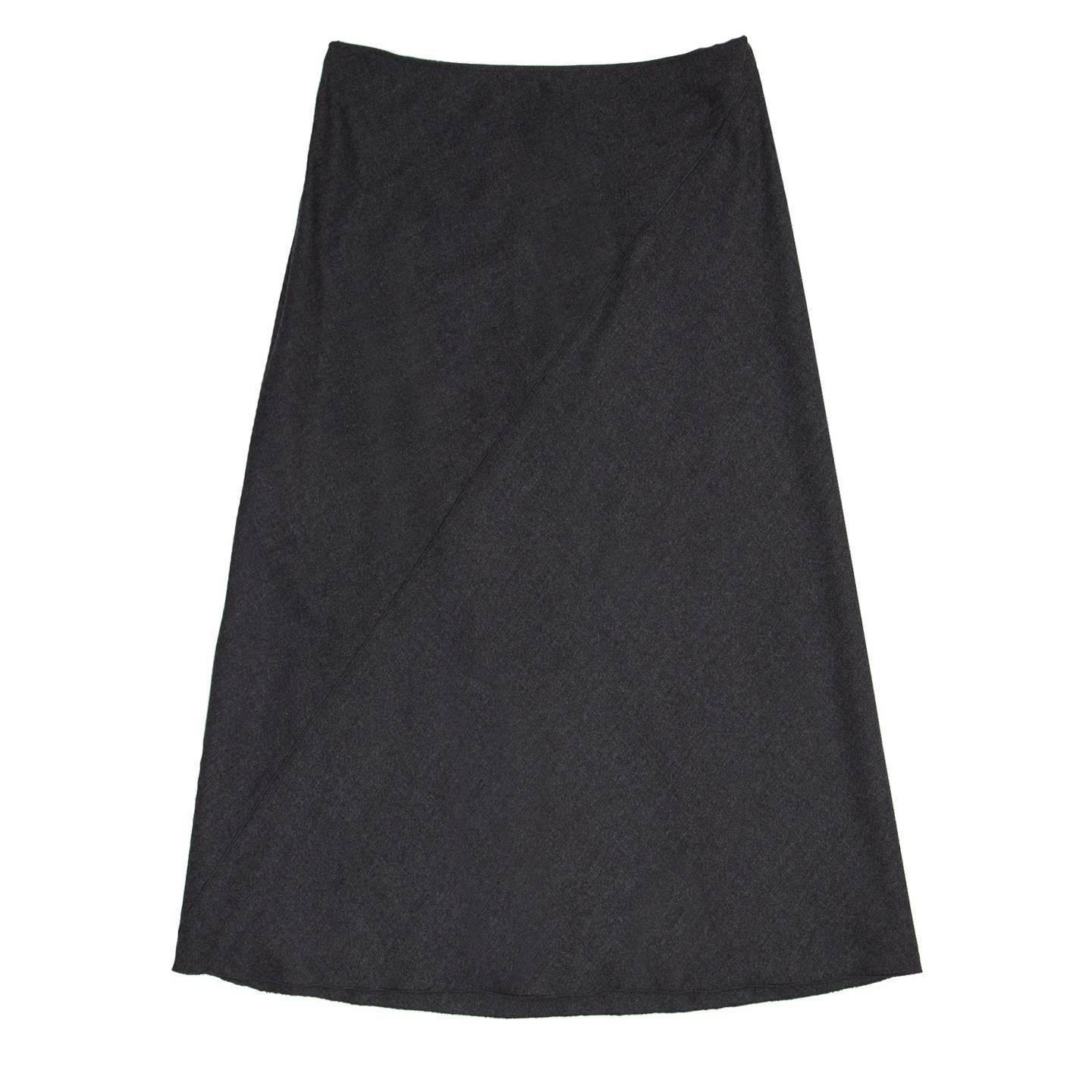 Charcoal grey fleece wool blend with elastane A-line with calf length. The skirt is made of oblique panels enriched by a tone-to-tone overlock as well as the hem. Made in Italy.

Size  42 French sizing

Condition  Excellent: worn once