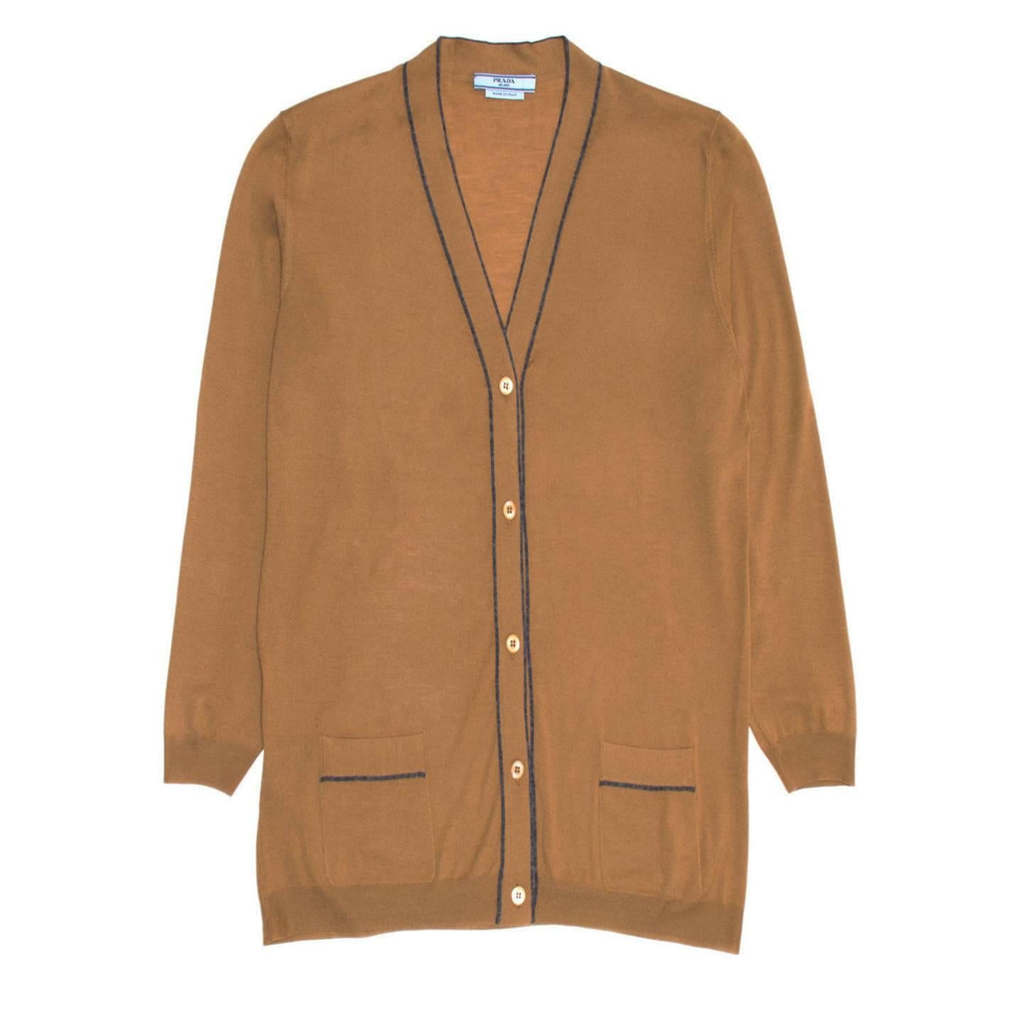 Prada caramel brown lightweight wool cardigan with V-neck and enriched by dark grey profiles around the neck, central front panels and pockets. The fit is straight and hip length. Made in Italy.

Size  46 Italian sizing

Condition  Excellent: never