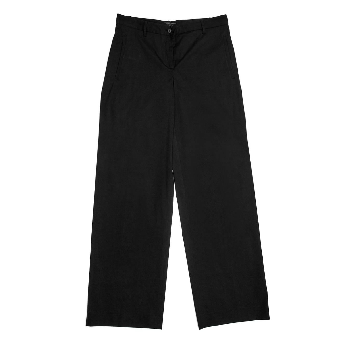 Prada black stretch cotton blend trousers with a man's style. The pants are flat with straight legs, vertical slash pockets at front and a slit pocket on the right back side that fastens with a tone-on-tone button. The waistband has thin belt loops