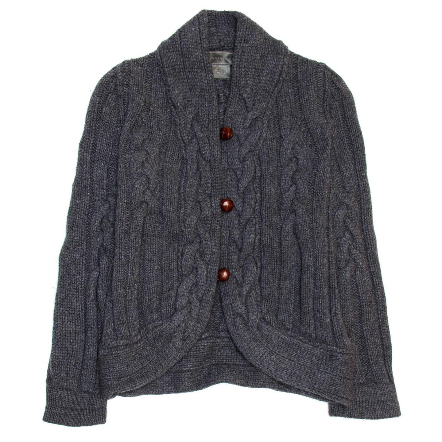Proenza Schouler grey cable knit waist length cardigan with shawl neck and brown leather buttons with an elegant loop closure.

Size  L Universal sizing

Condition  Excellent: worn once