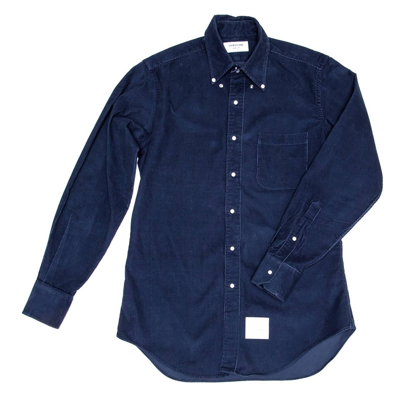 Thom Browne denim blue cotton corduroy shirt with button down collar, white mother-of-pearl snap buttons in a metal frame and a patch pocket at bust. Made for Man. Made in U.S.A.

Size  4

Condition  Excellent: never worn