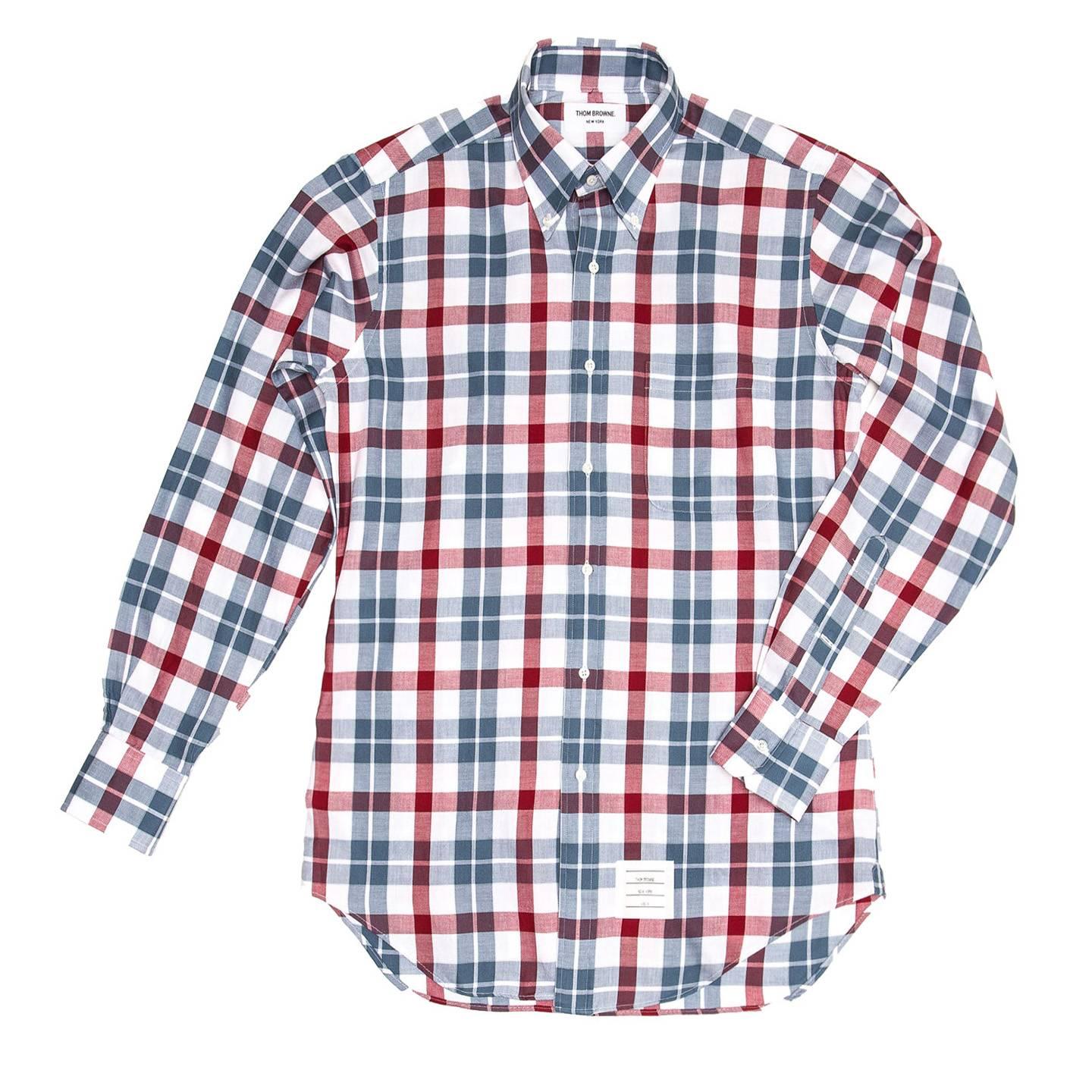 Thom Browne Sky blue, white and red plaid cotton flannel shirt with button down collar, white mother-of-pearl buttons and a patch pocket at bust. Made for Man. Made in U.S.A

Size  4

Condition  Excellent: never worn