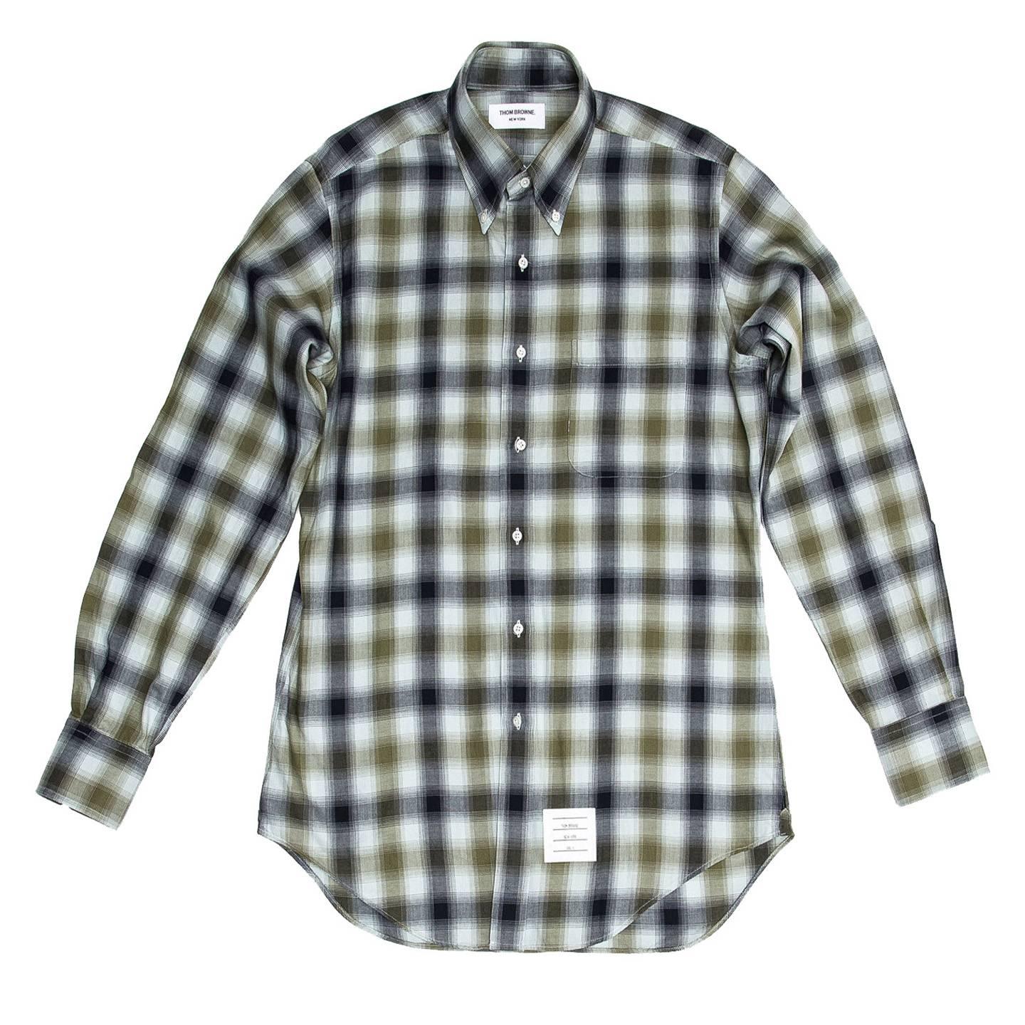 Thom Browne navy blue, baby blue and pine green plaid cotton flannel shirt with button down collar, white mother-of-pearl buttons and a patch pocket at bust. Made for Man. Made in U.S.A.

Size  4

Condition  Excellent: never worn