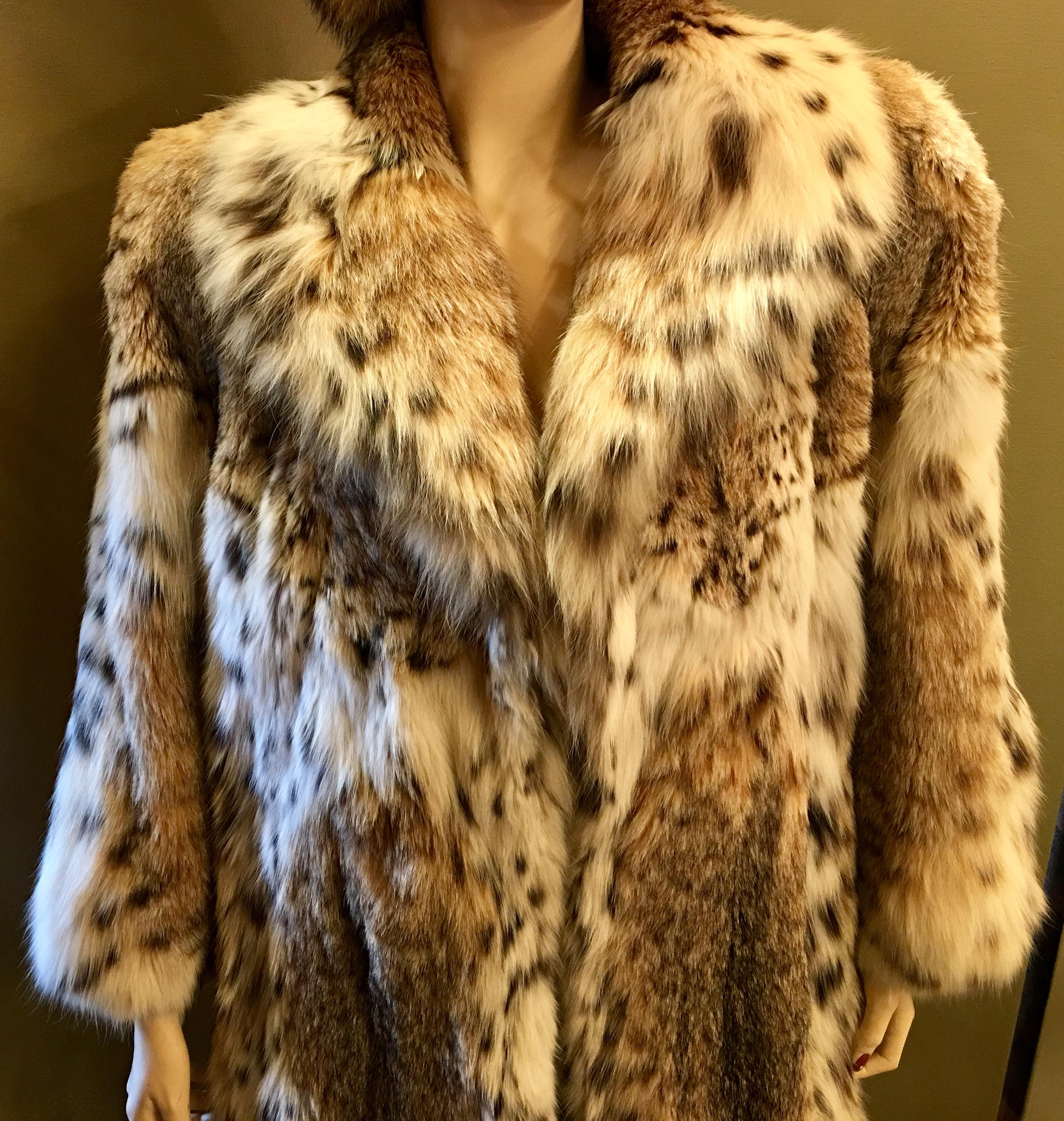 Gorgeous and very sexy, luxurious lynx coat is 3 quarter length of natural, ultra soft, spotted lynx fur with a large and stylish shawl collar. Coat features 2 velvet lined slash pockets and closes with 3 hooks and eyes.

Lynx fur is distinctively