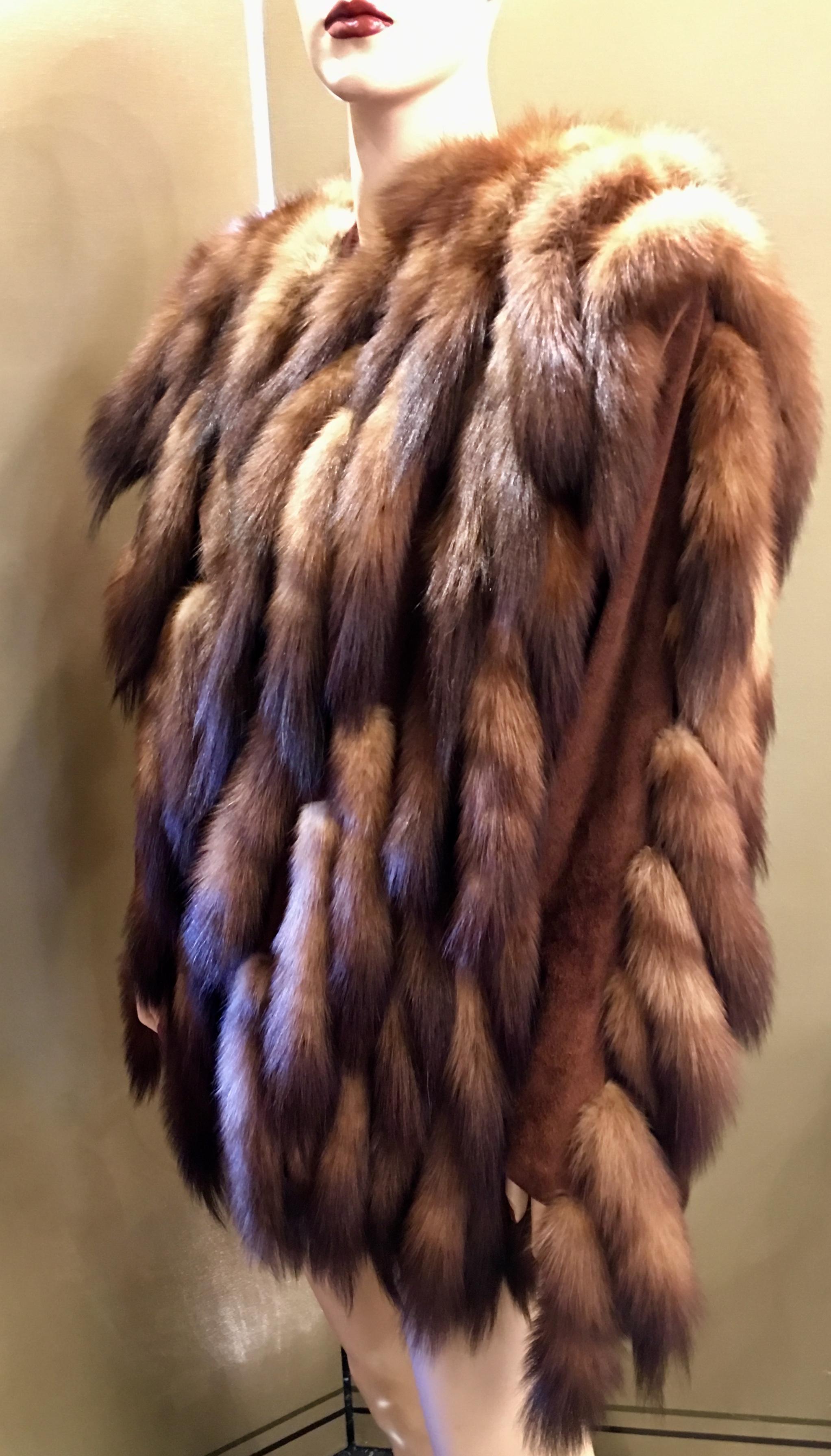 Fantastically styled, high fashion, brown suede jacket is covered in ultra soft Russian sable tails and is lined in cinnamon colored moire fabric with hook and eye closure.

The fur is in excellent condition.  The coat can fit a size small or