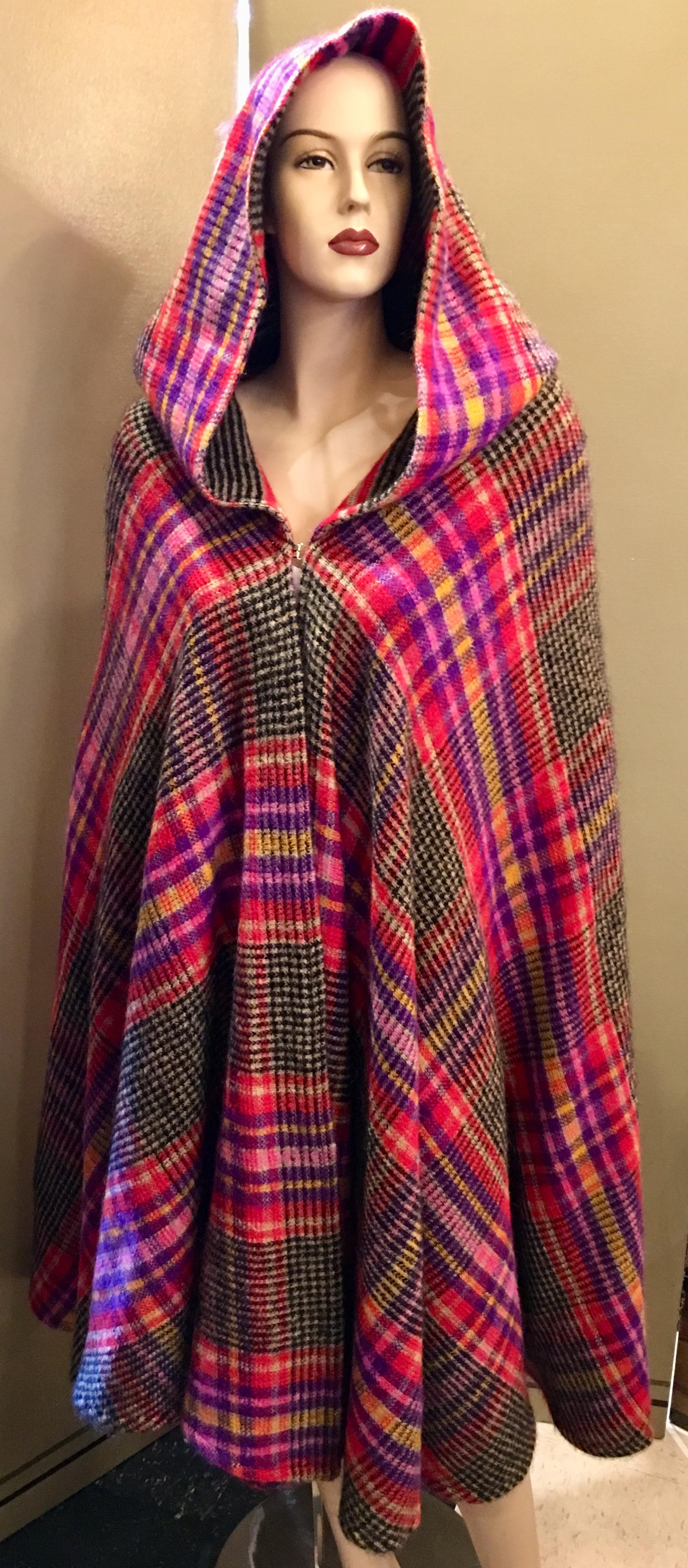 Colorful, heavy, knitted vintage mohair wool, plaid hooded cape from Italian high end, couture fashion designer, Missoni, features a complementary, color coordinated, striped interior and a rounded, circle hemline. Closes with a hook and eye at the